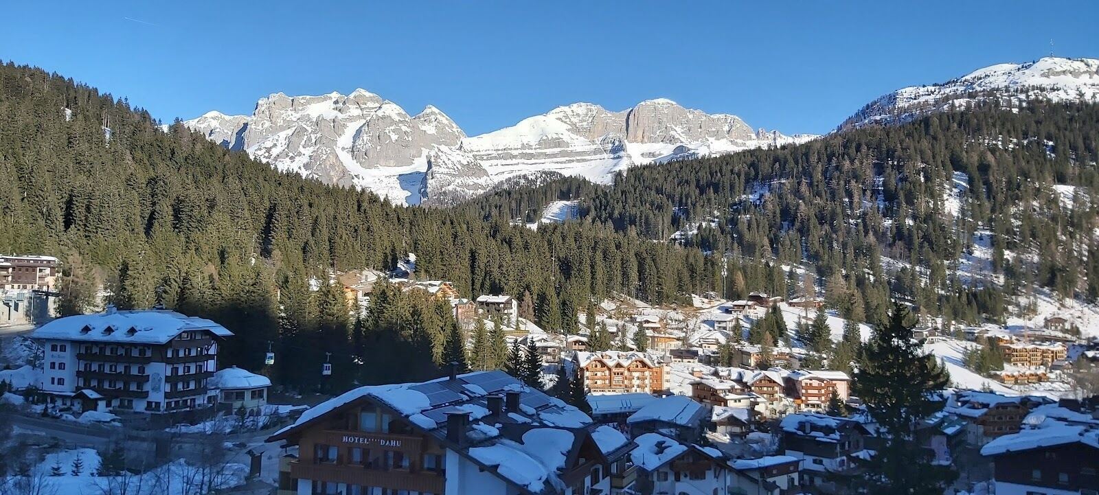 The elegant town of Madonna di Campiglio below the dramatic Brenta Dolomite peaks in snow