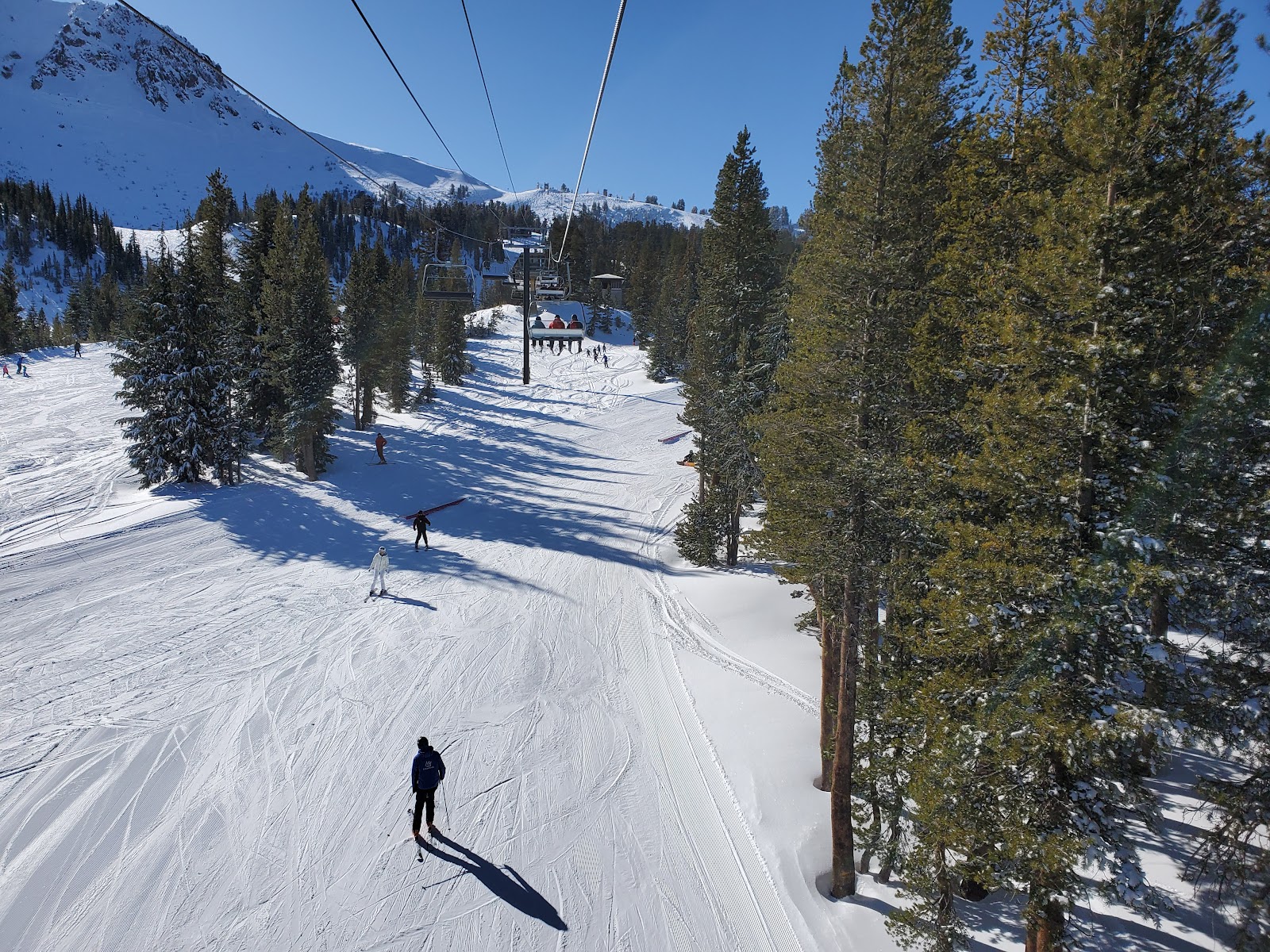A skier in deep powder on a steep Sierra face at Mammoth