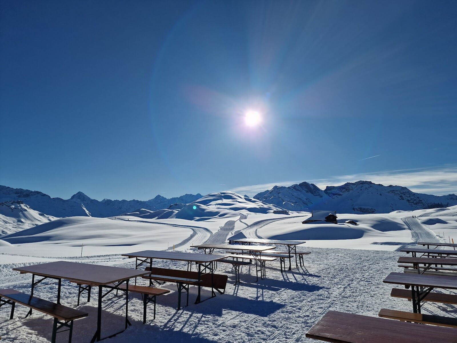 Gentle sunny pistes on the Melchsee Frutt plateau with central Swiss peaks behind