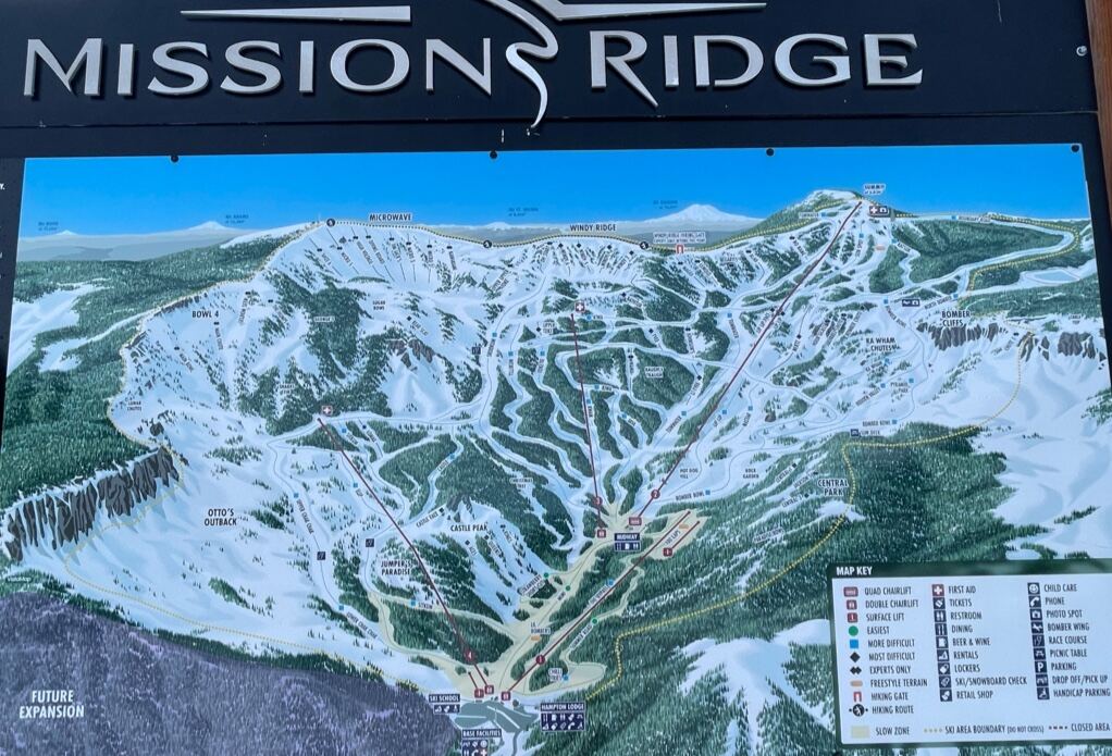 Skiers on a sunny uncrowded run above the Columbia valley at Mission Ridge