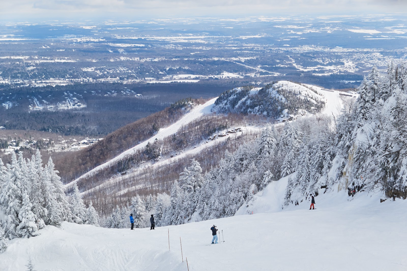 Snow covered slopes and chairlift across the peaks of Mont Orford