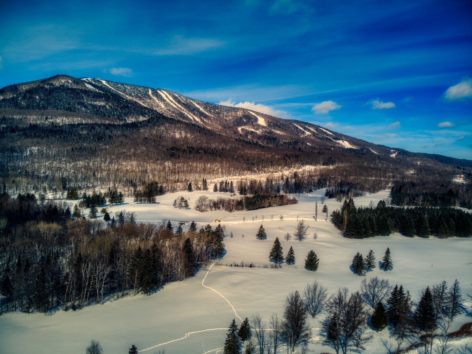 Long groomed ski run descending Mont Sainte Anne in Quebec
