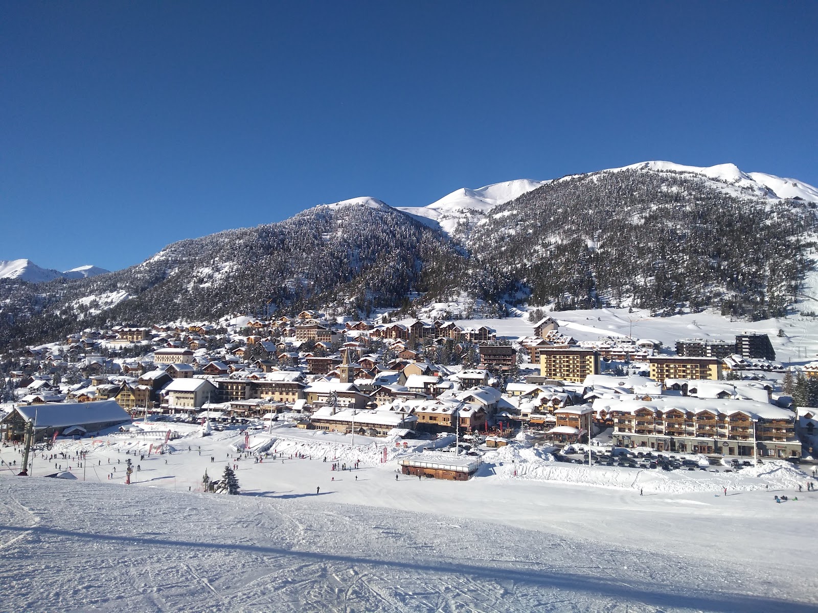 Skiers on a groomed run in the Via Lattea cross border ski area