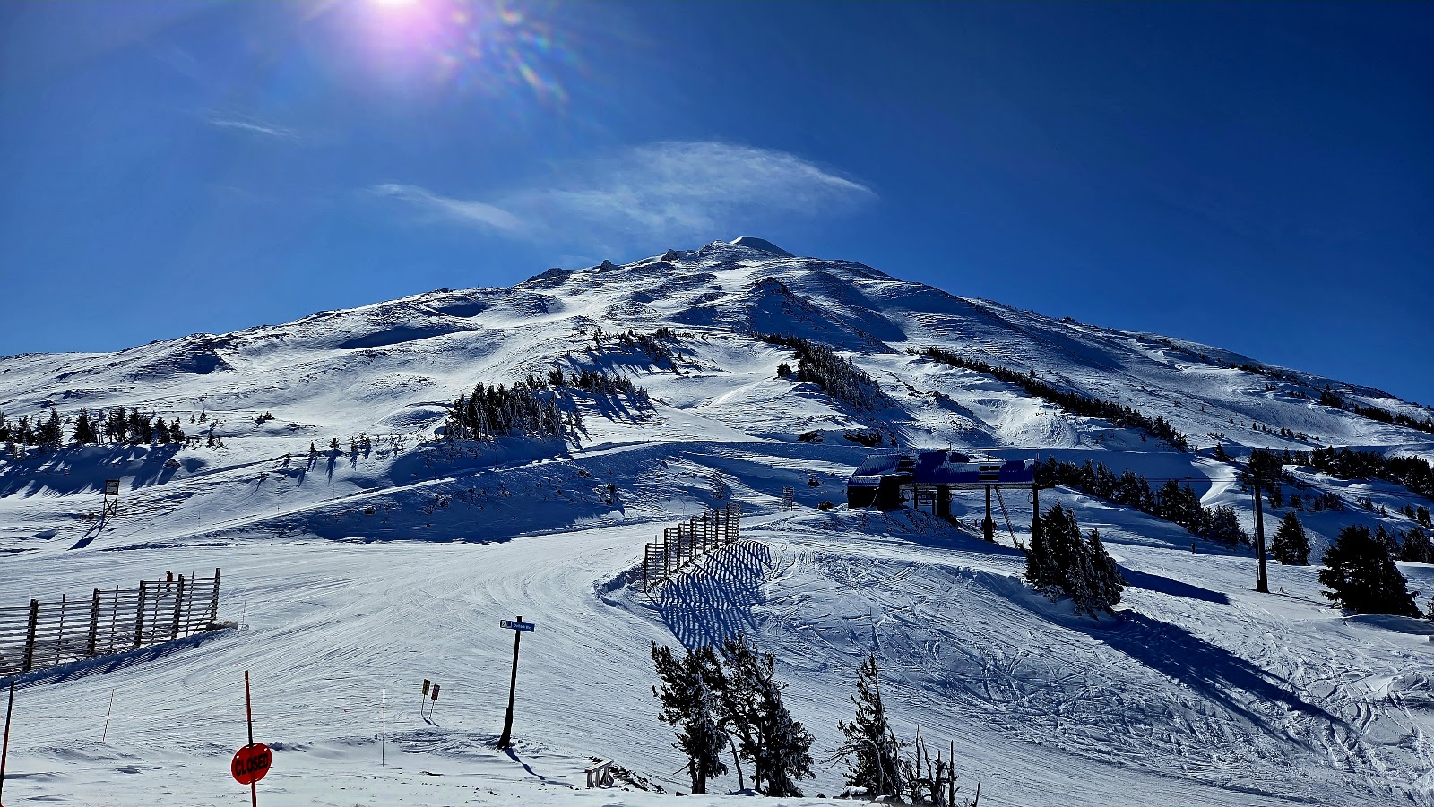 A chairlift climbing the snowy slopes of Mount Bachelor