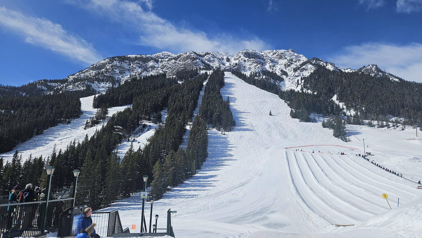 Quiet groomed blue runs at Mt Norquay with the Rockies behind