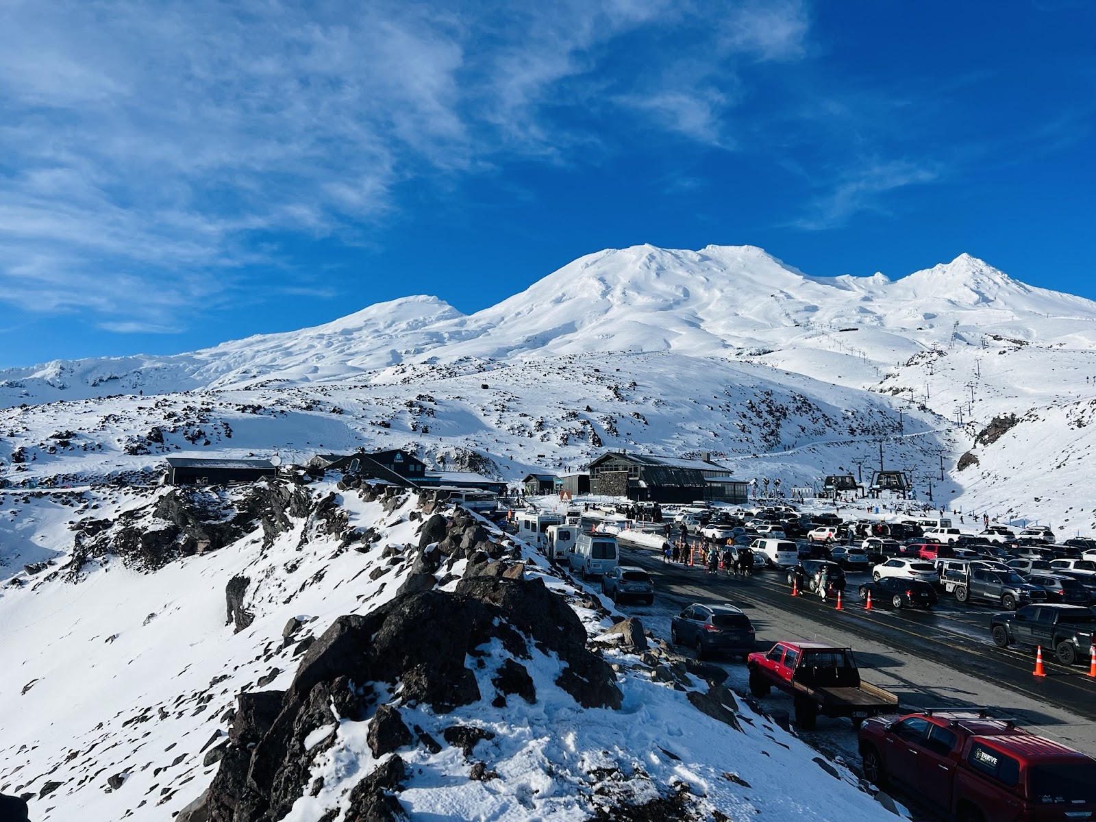 Skiers on a wide open snow slope on Mt Ruapehu in New Zealand