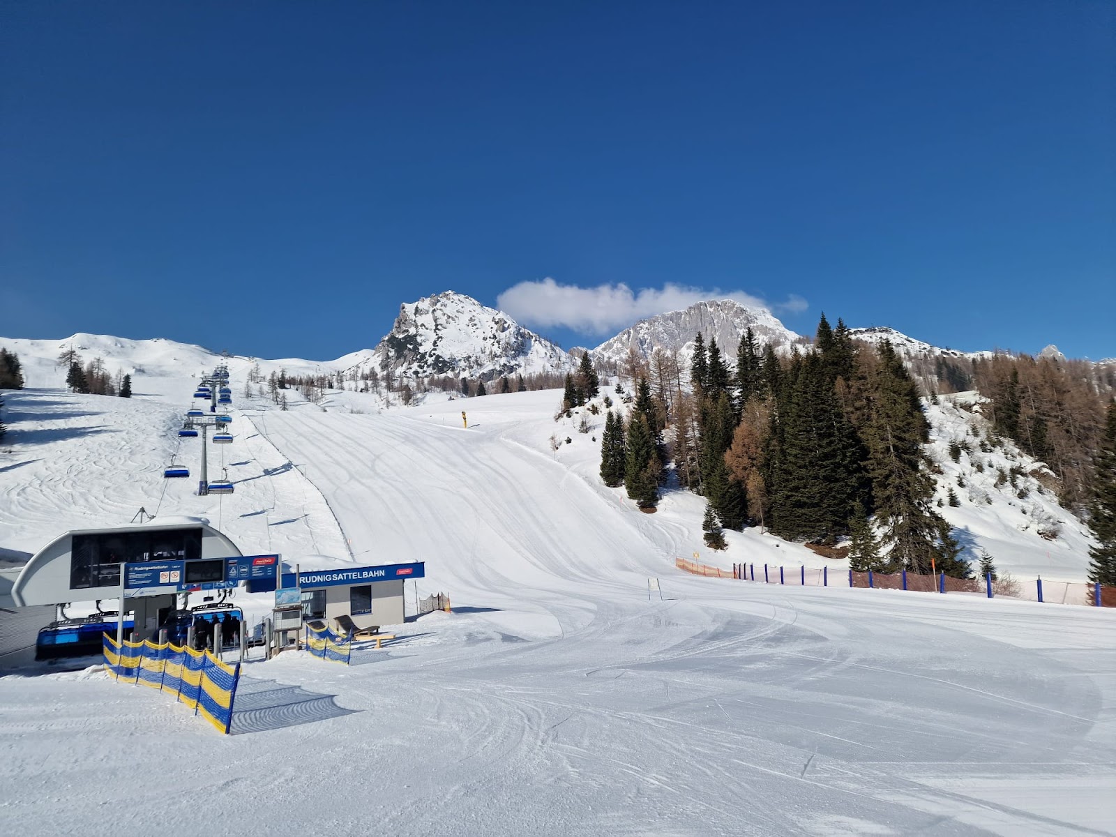 Skiers on a groomed run near the Italian border at Nassfeld