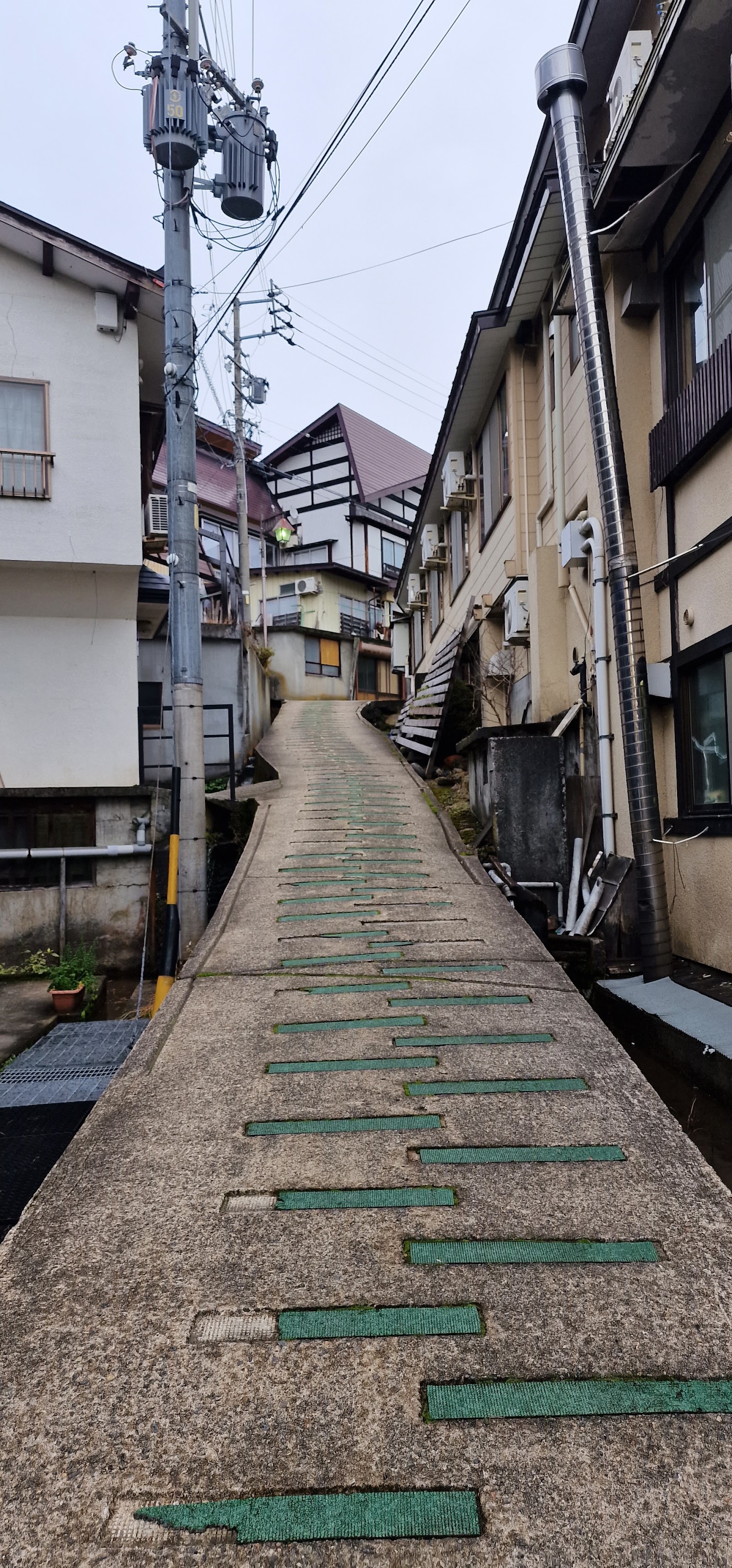 Snow covered onsen village streets below the slopes at Nozawa Onsen