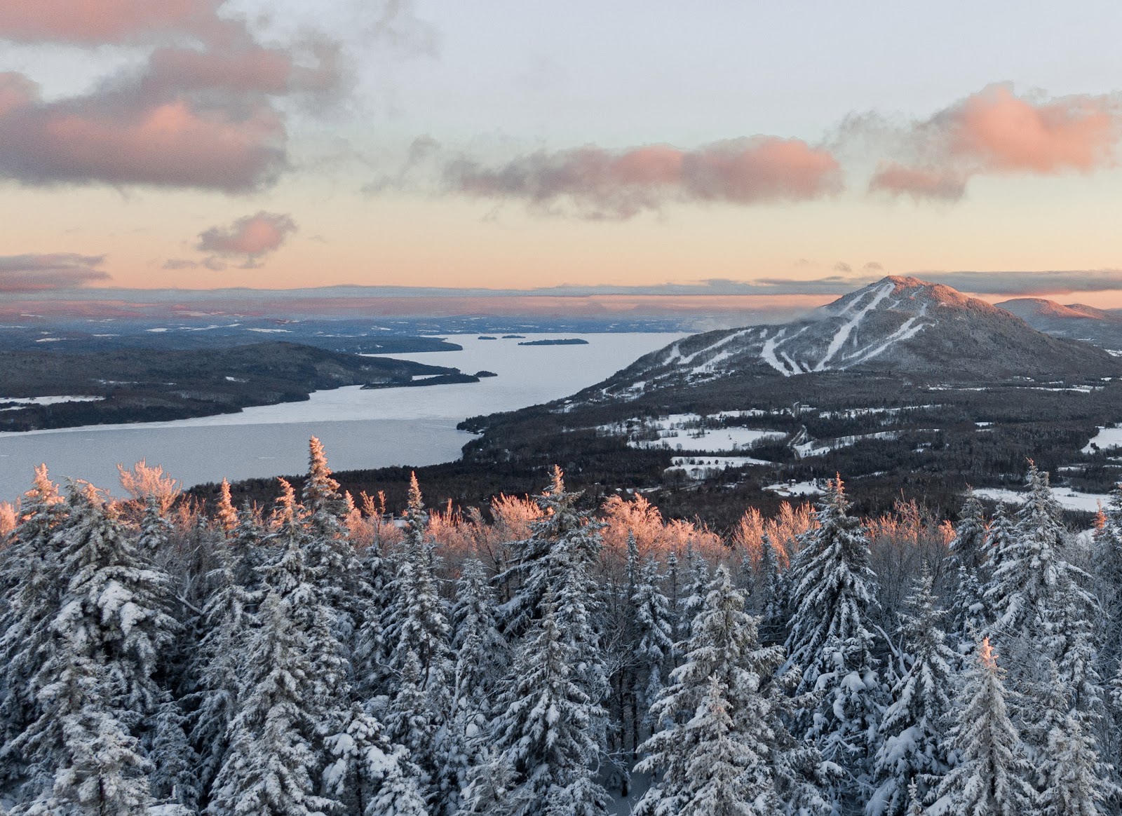 Groomed runs dropping toward frozen Lake Memphremagog at Owls Head in Quebec