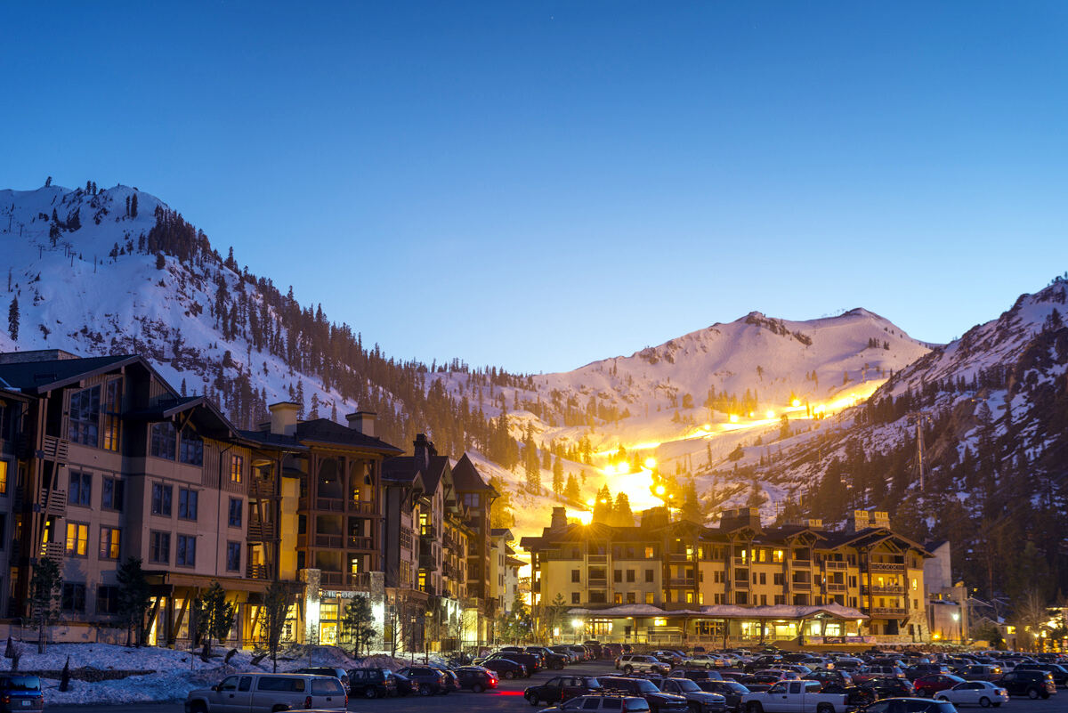 Snowy Sierra peaks above the base village at Palisades Tahoe in California