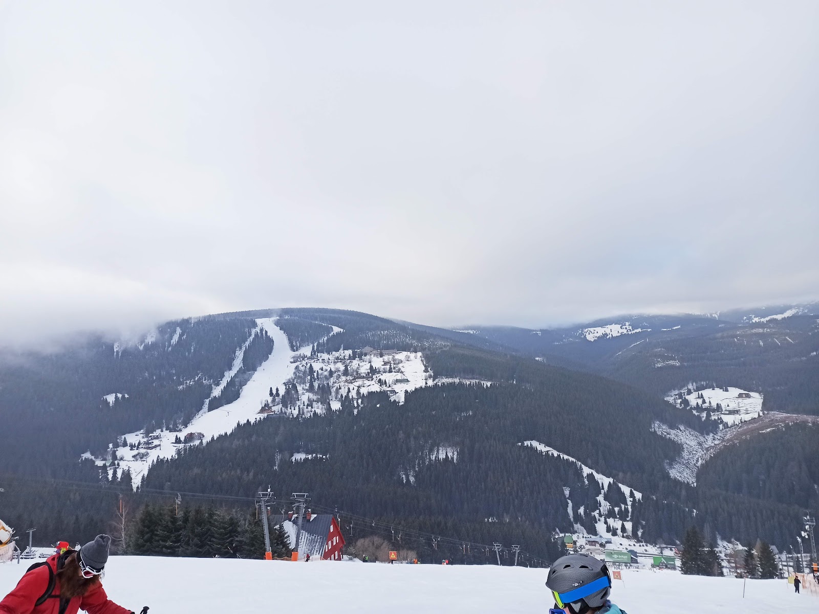 Timber chalets and a small mountain town under deep winter snow