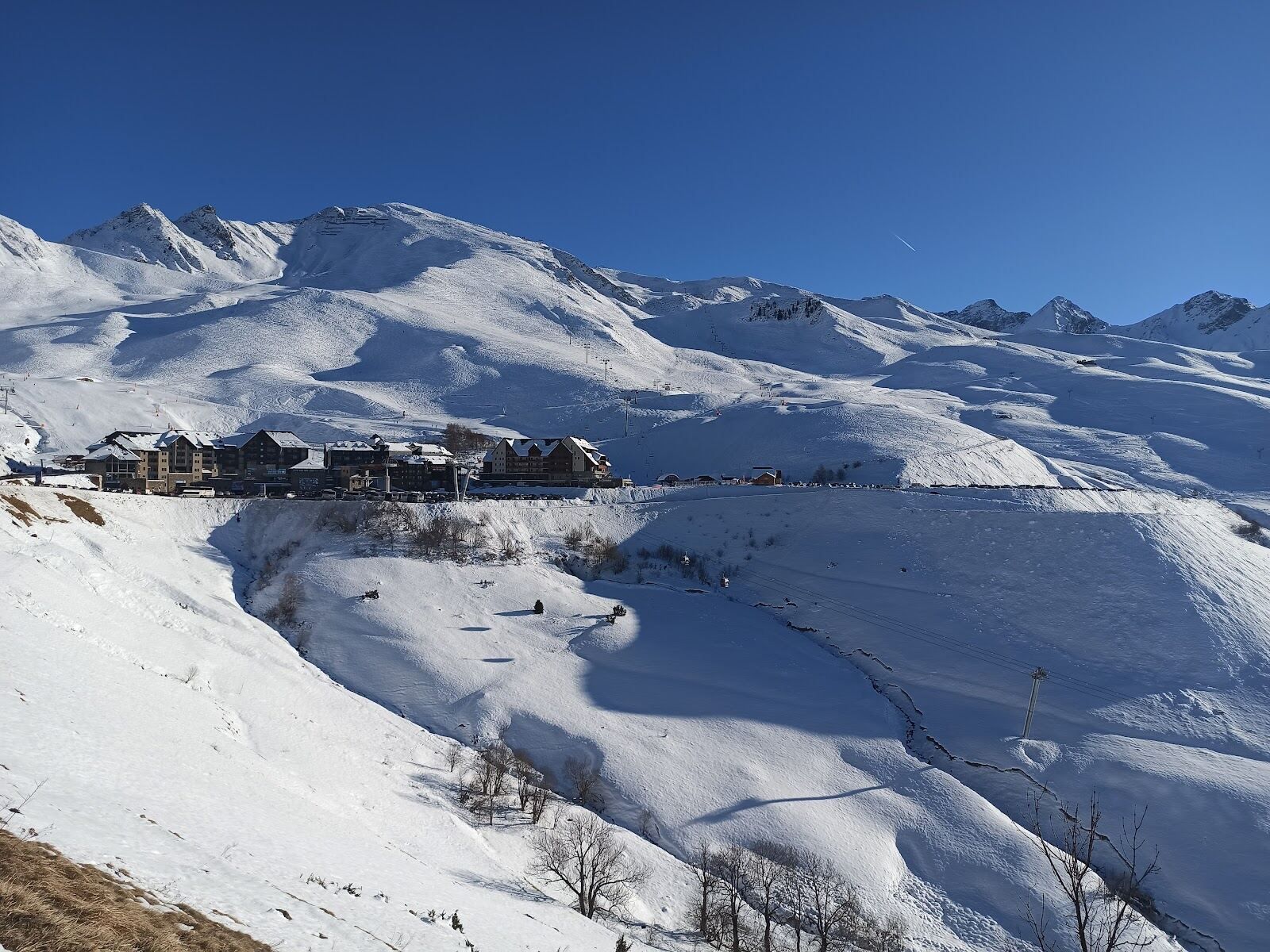 Sunny modern slopes above the Peyragudes bases under blue sky