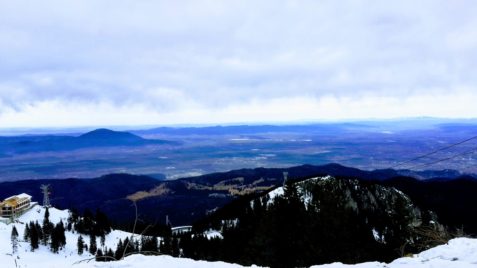 Skiers on a wide gentle blue run in soft winter light