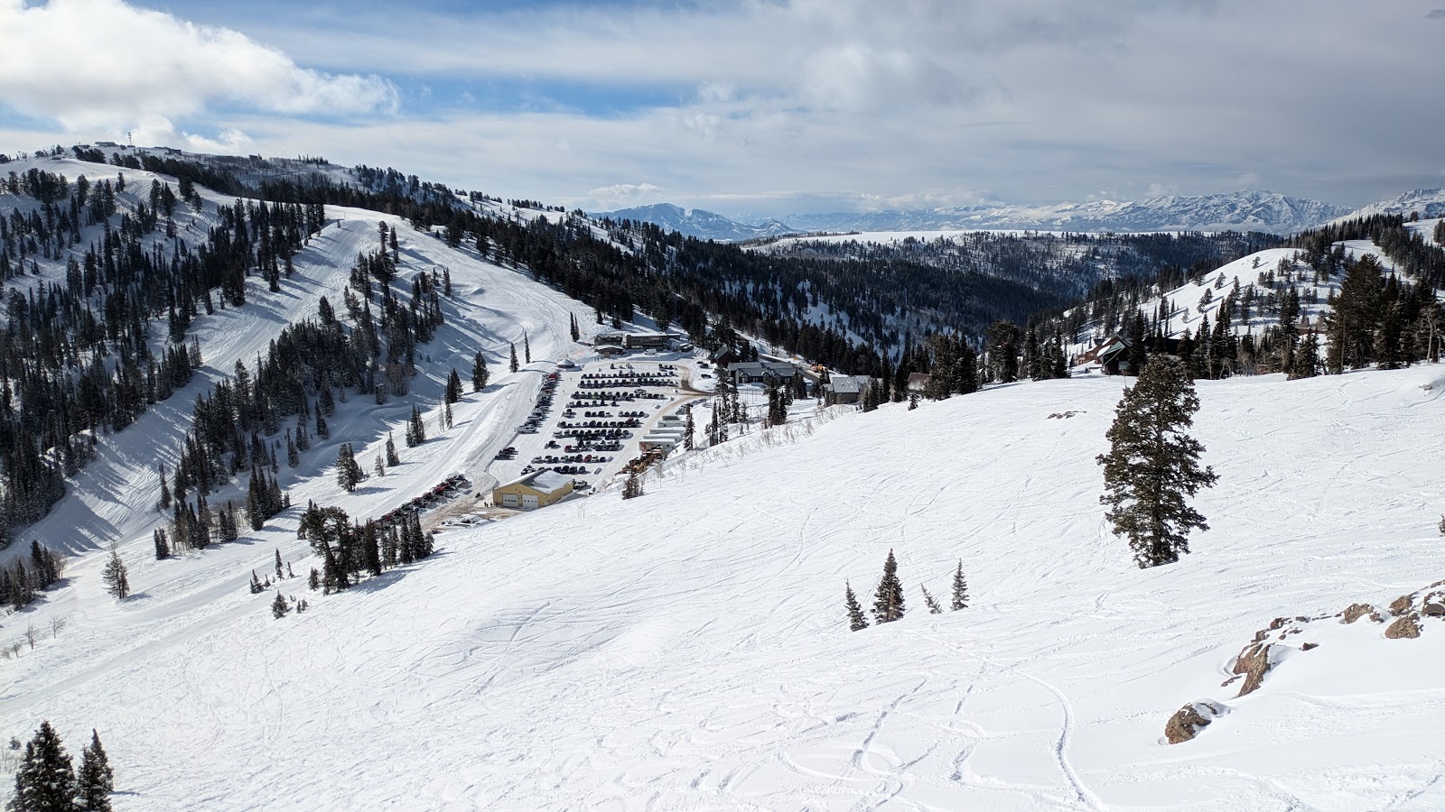 A skier in deep dry powder on the wide open terrain of Powder Mountain in Utah