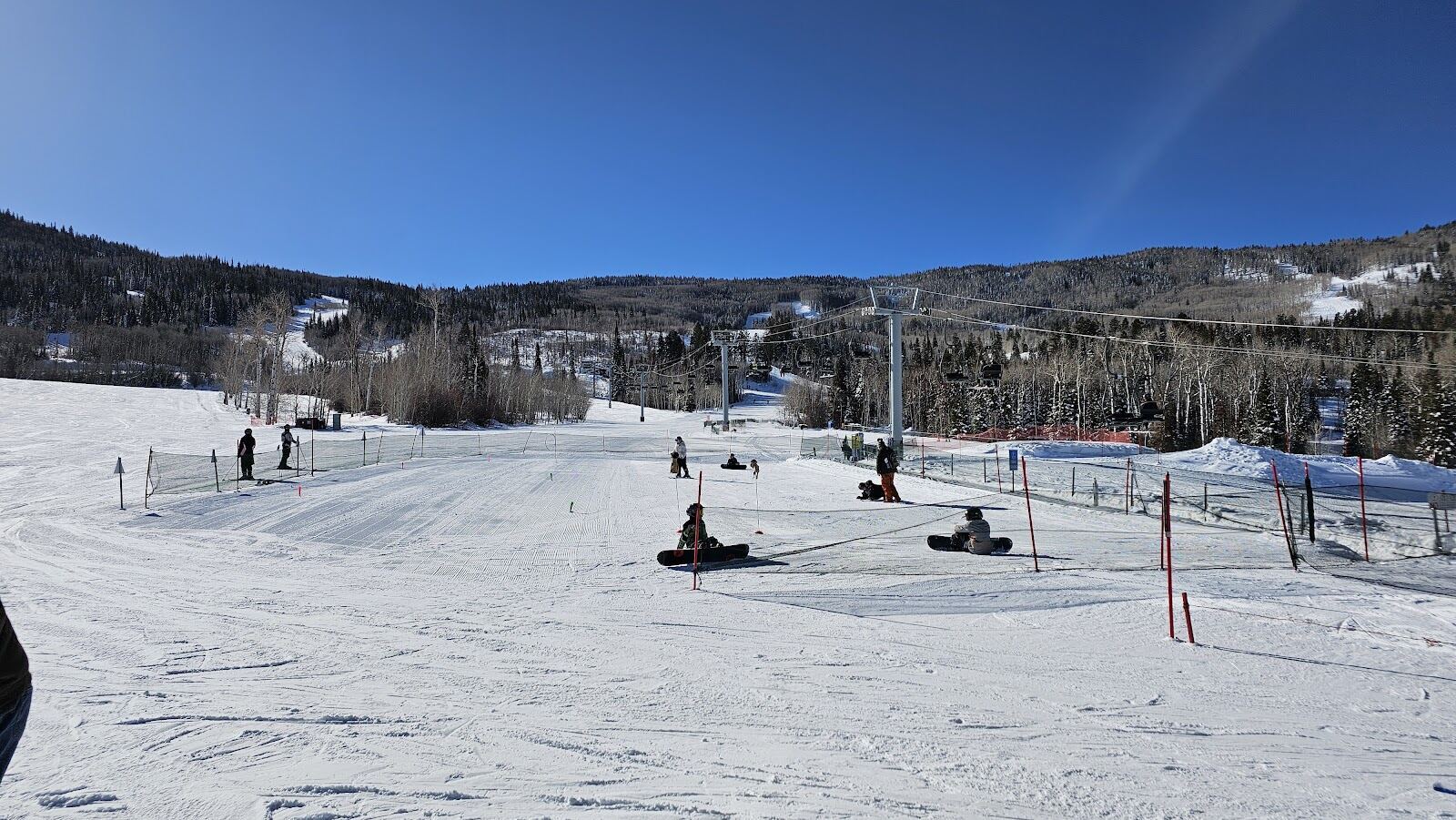 Empty groomed runs and blue sky above the Grand Valley