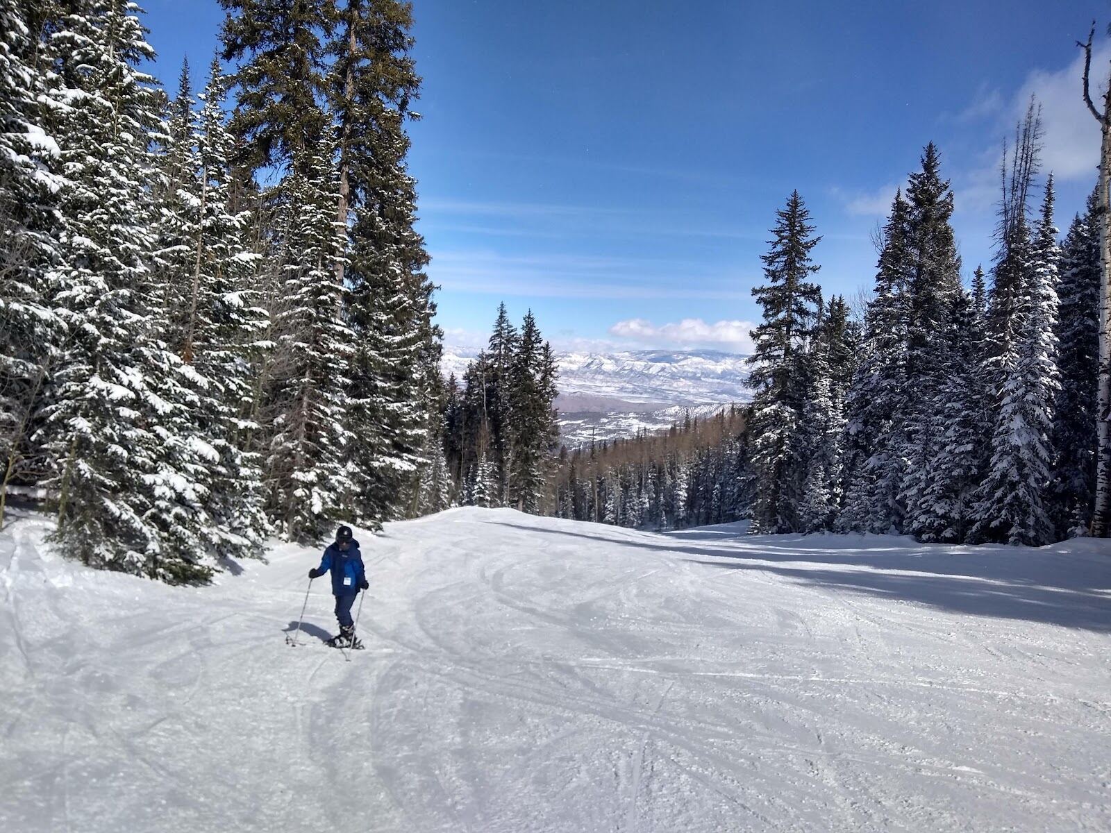 Chairlift climbing the gentle slopes of Powderhorn in winter