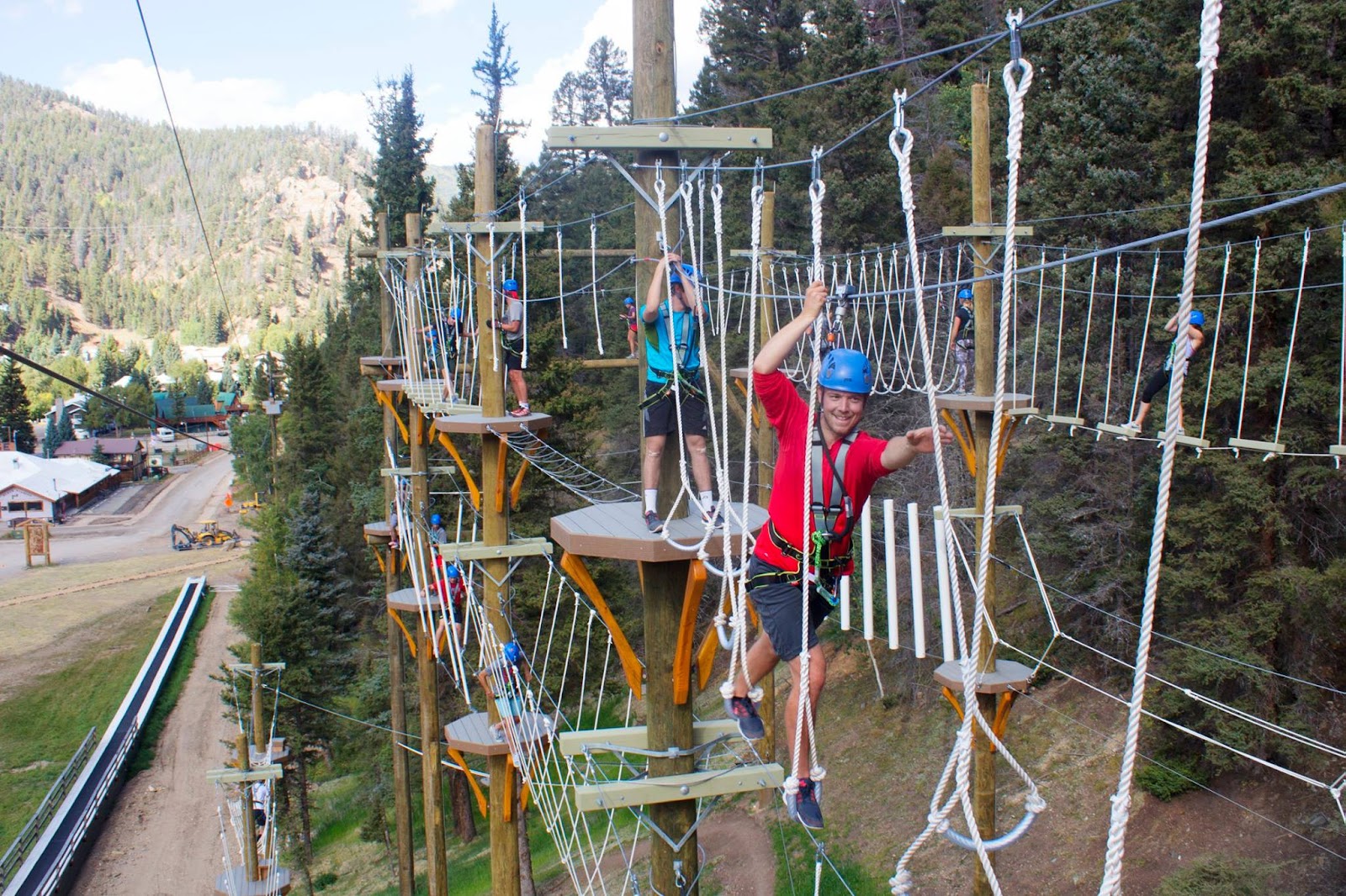Skiers on a gentle groomed run above the town of Red River