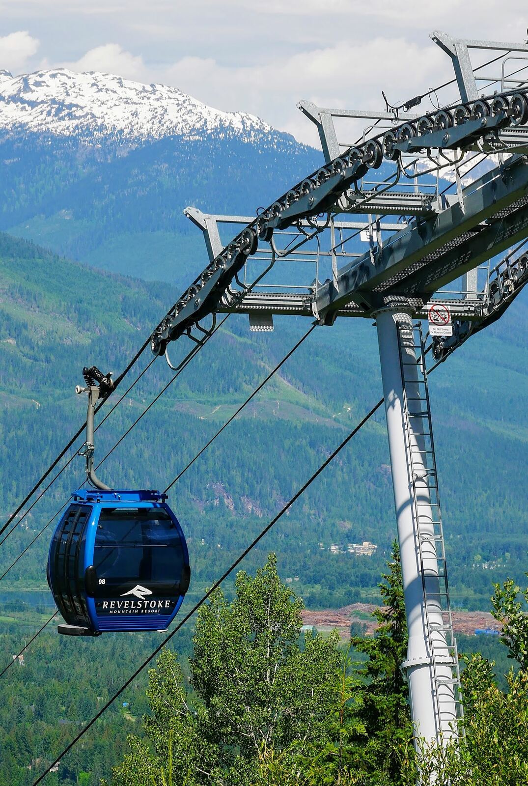 A long gondola climbing forested powder slopes at Revelstoke