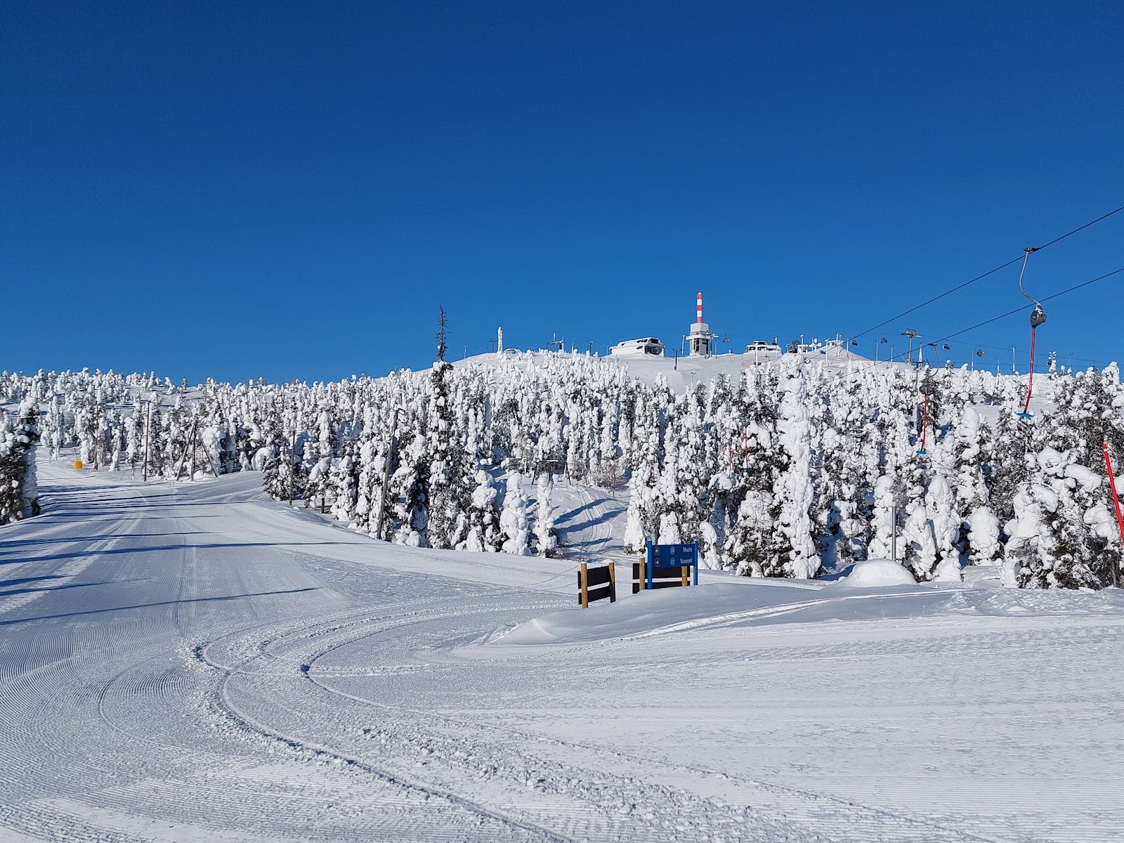 Frost covered forest and a chairlift at Ruka in deep winter