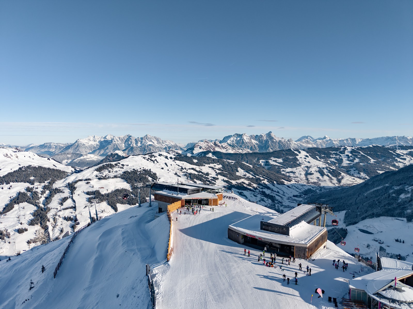 The sunny village of Saalbach in winter ringed by ski slopes and lifts