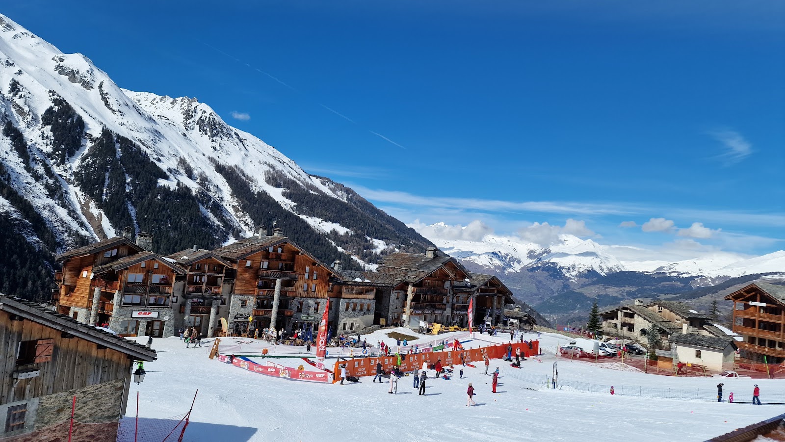 Skiers in fresh snow on an open slope at Sainte Foy