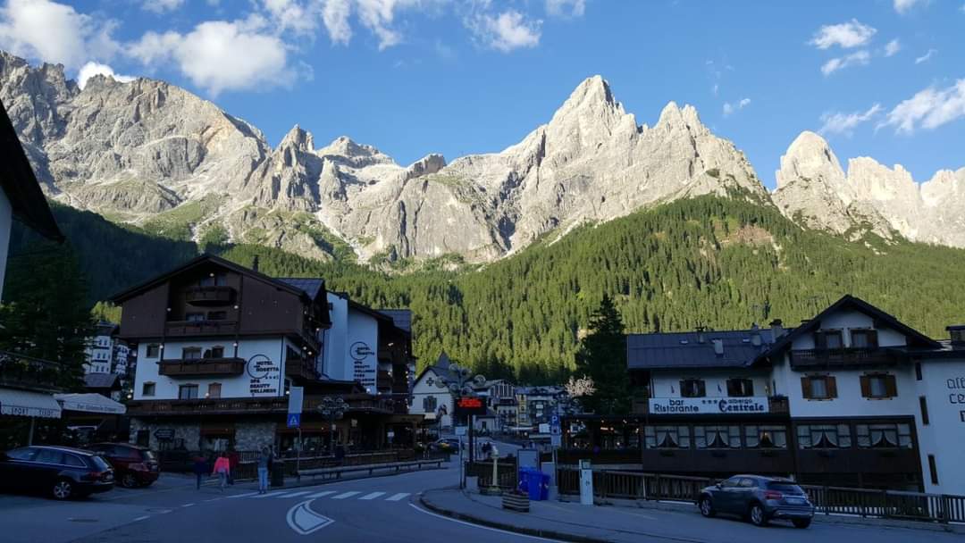 The Pale di San Martino towering above the forested resort in winter