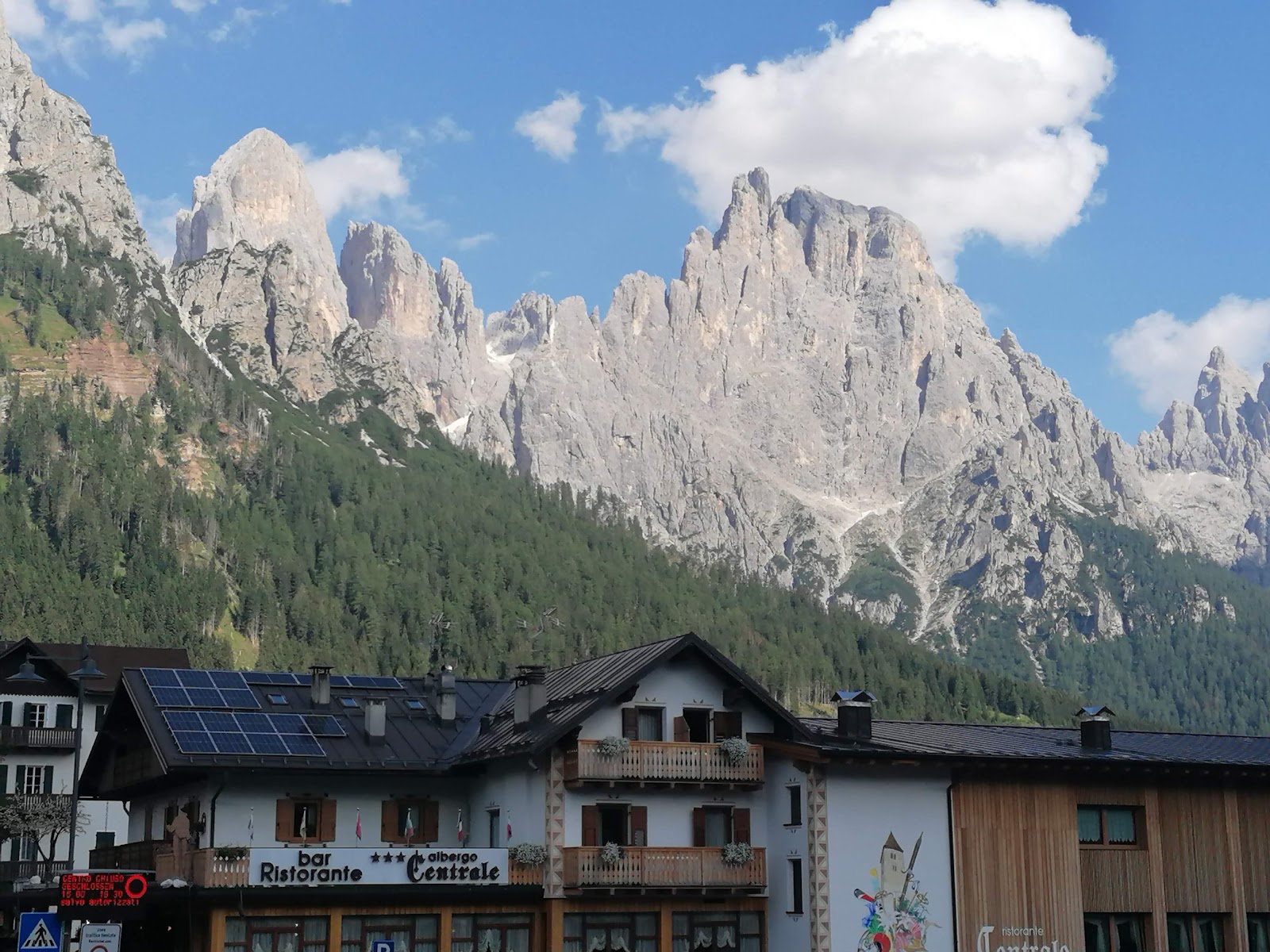 Chairlift rising toward Cima Tognola under the Dolomite walls