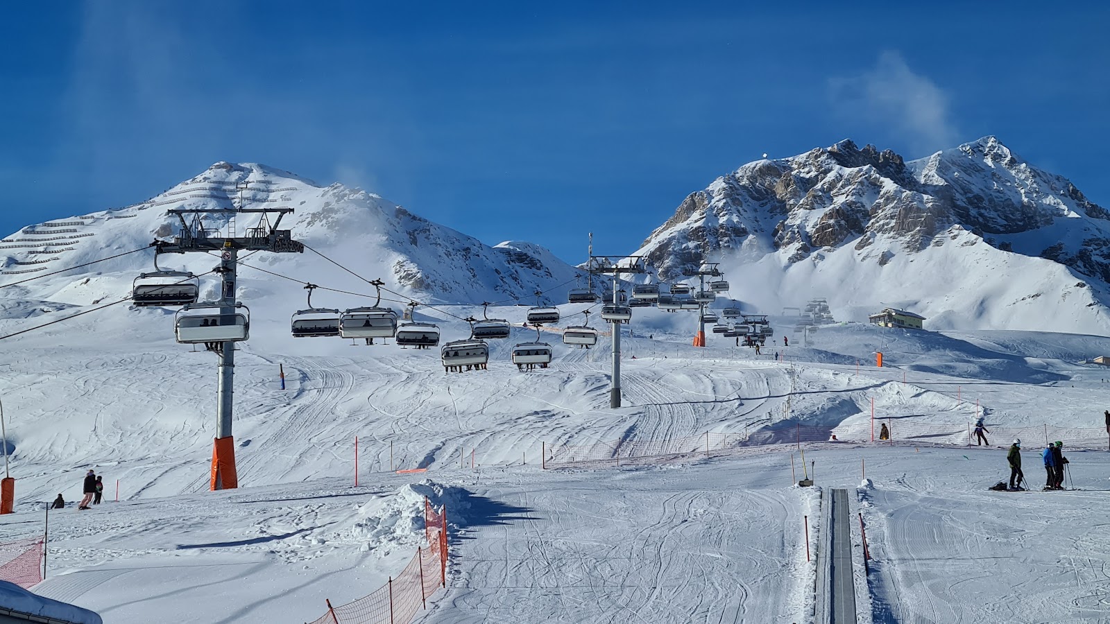 Skier in fresh snow on the slopes above Scuol