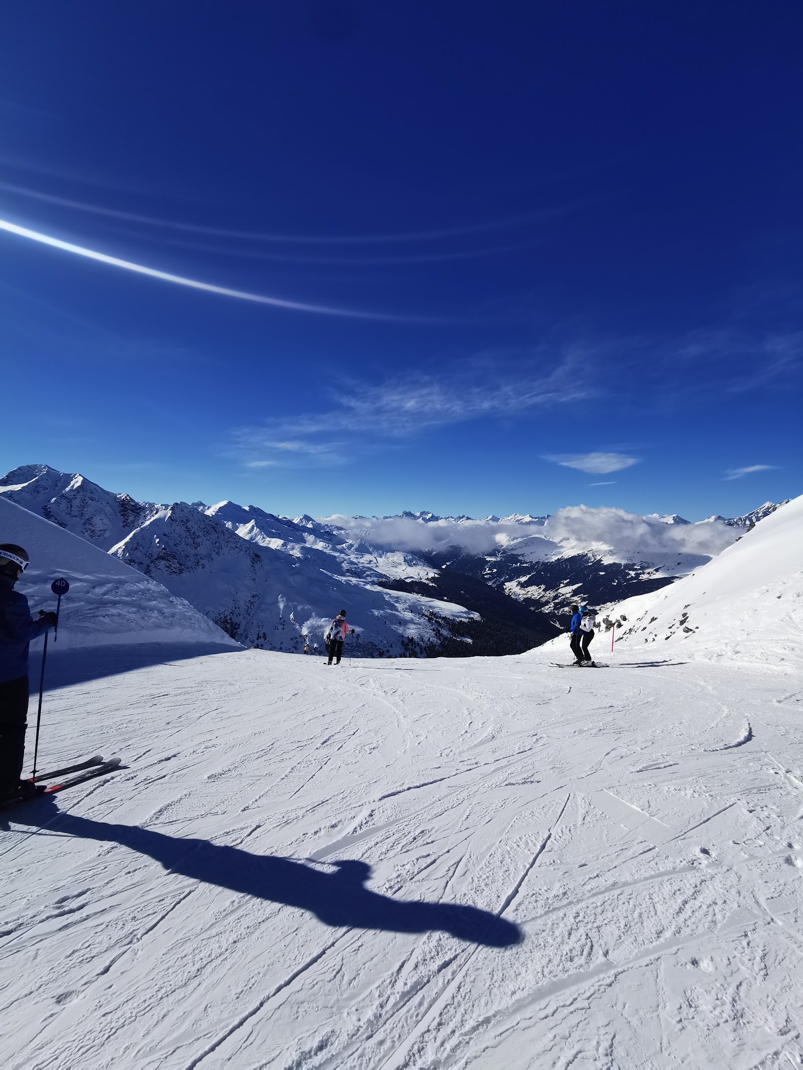 Skiers riding a chairlift over the See ski area