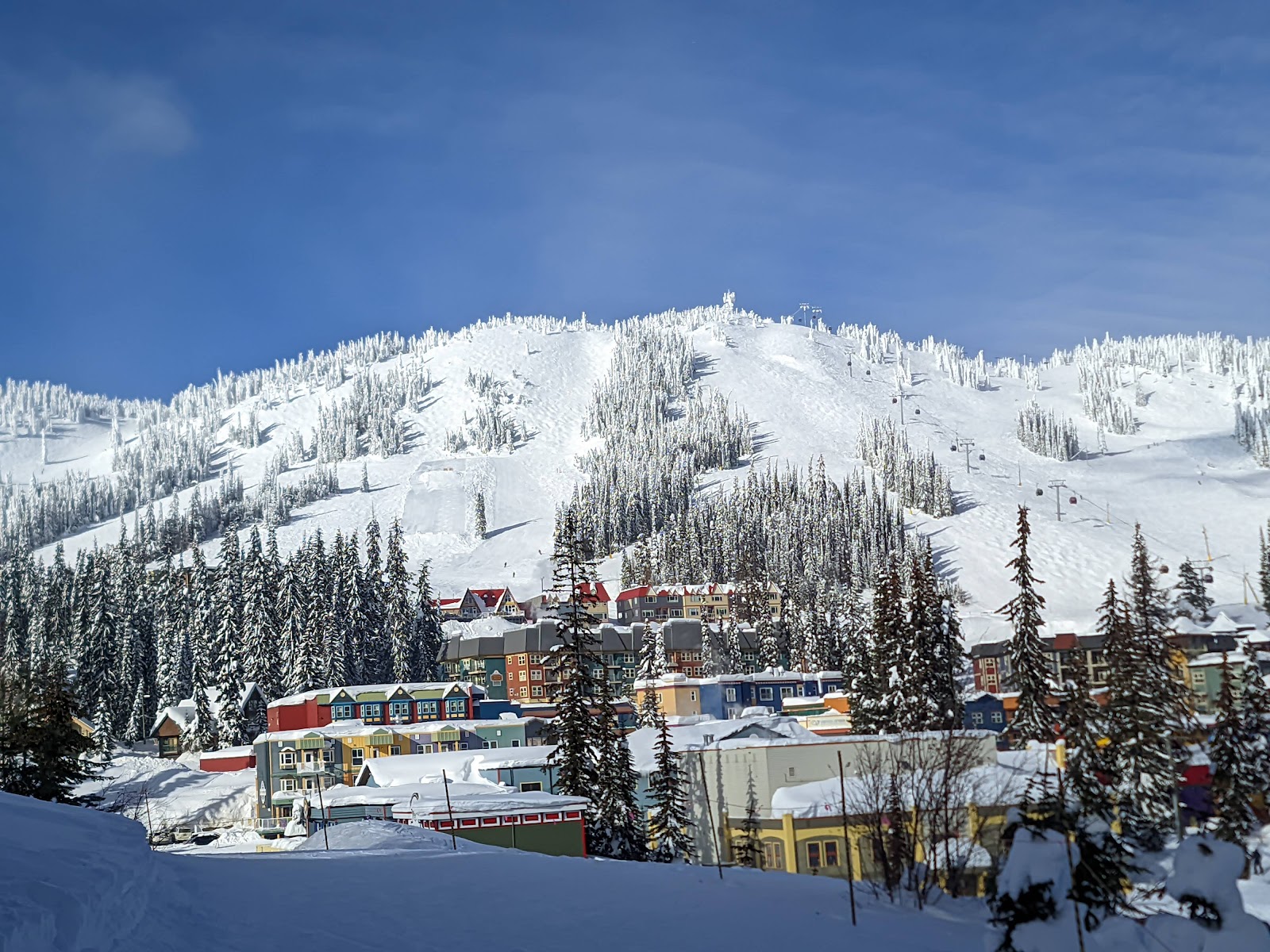 Colorful Victorian village and snowy slopes at SilverStar in British Columbia