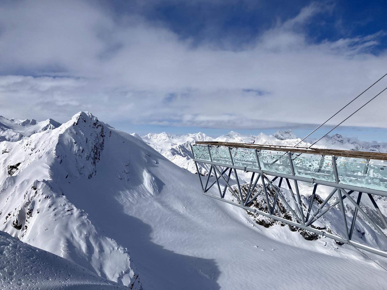 High glacier pistes above the town of Solden in the Otztal under blue sky