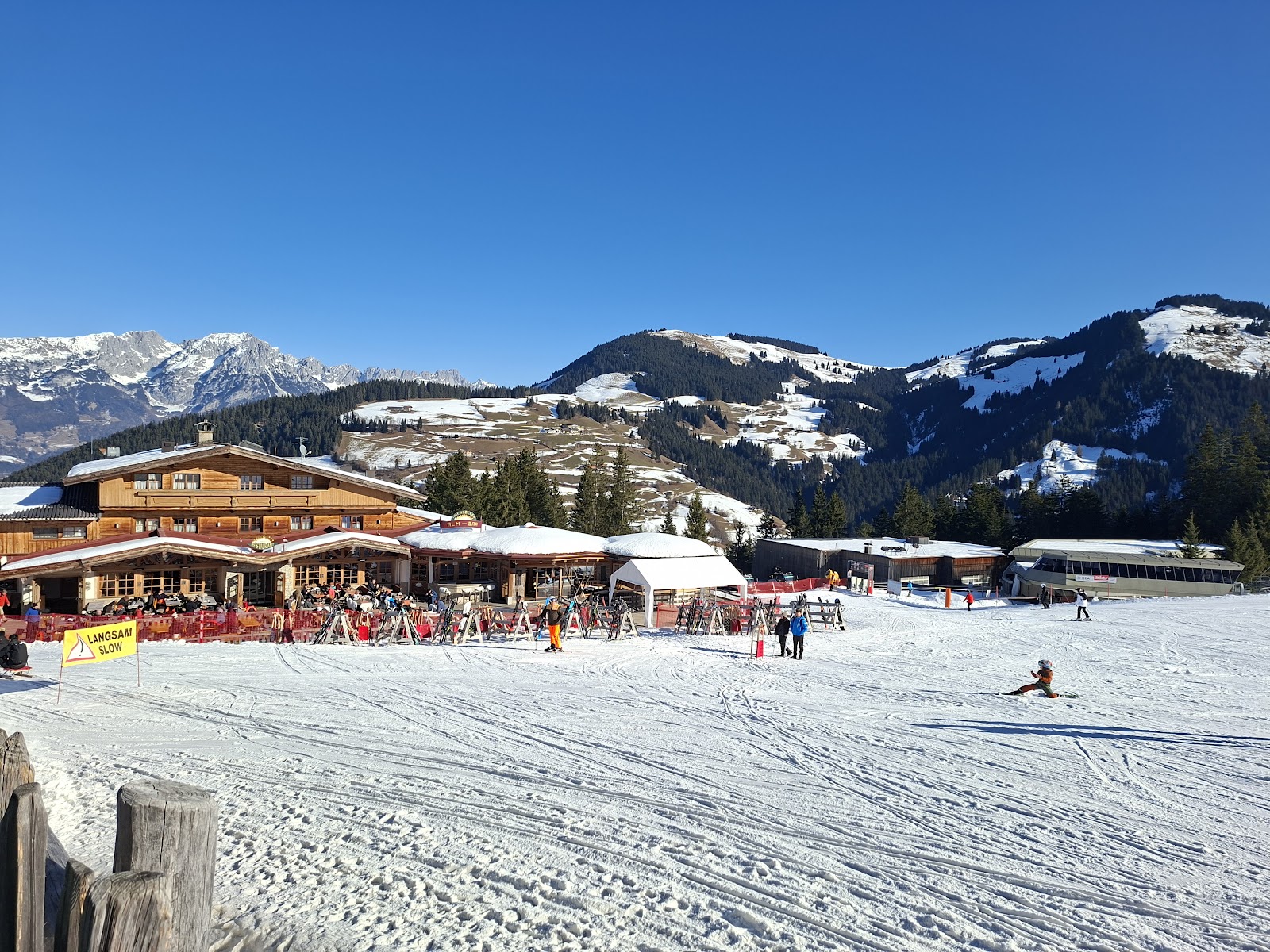 The village of Soll with its onion domed church under snow and mountains behind
