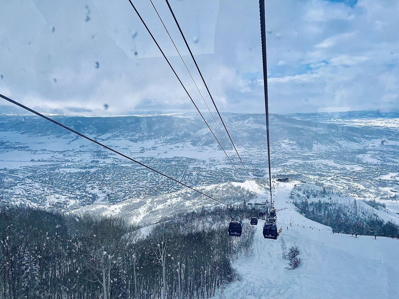 Wide groomed intermediate runs under blue sky at Steamboat ski resort