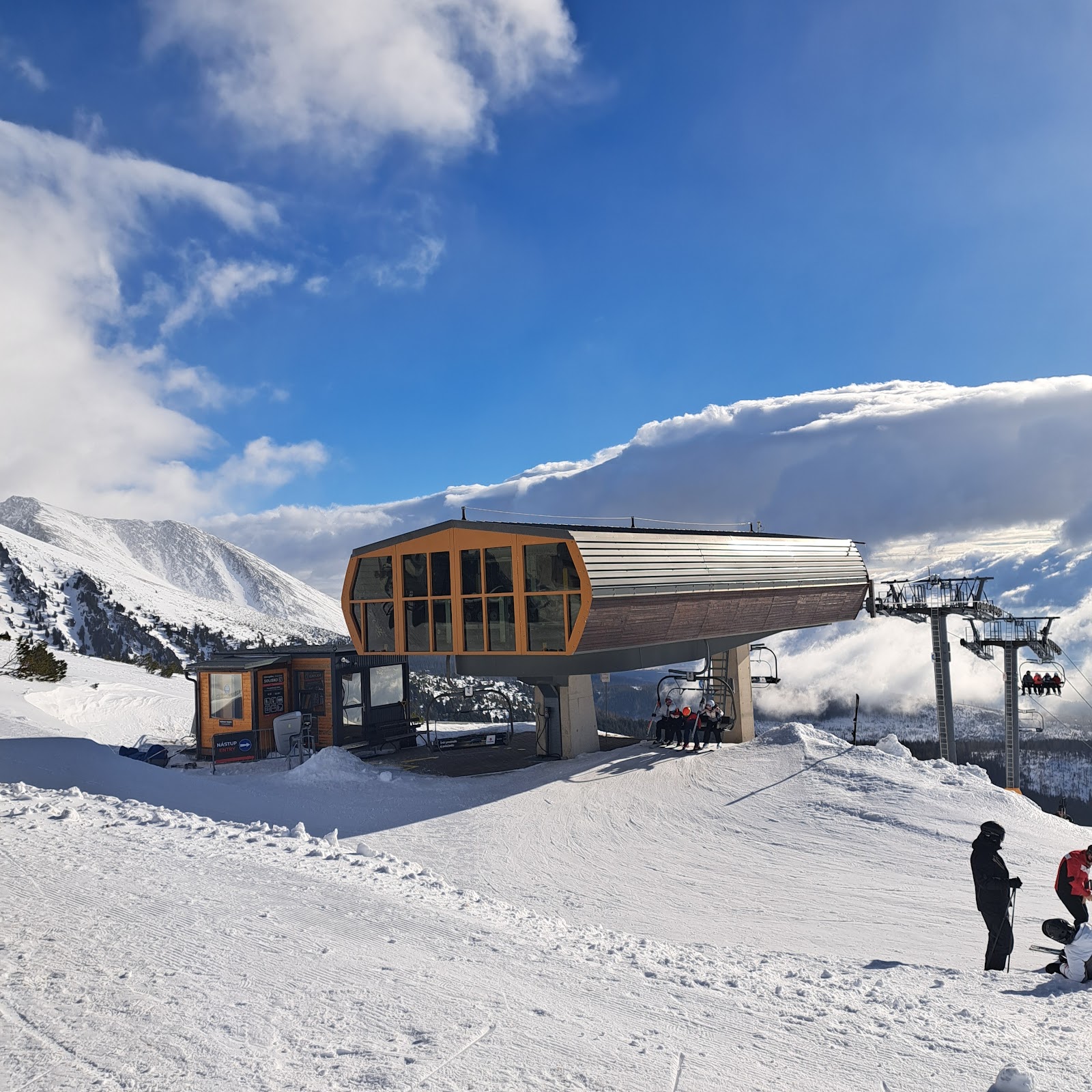 Timber hotels and a ski jump tower under deep winter snow