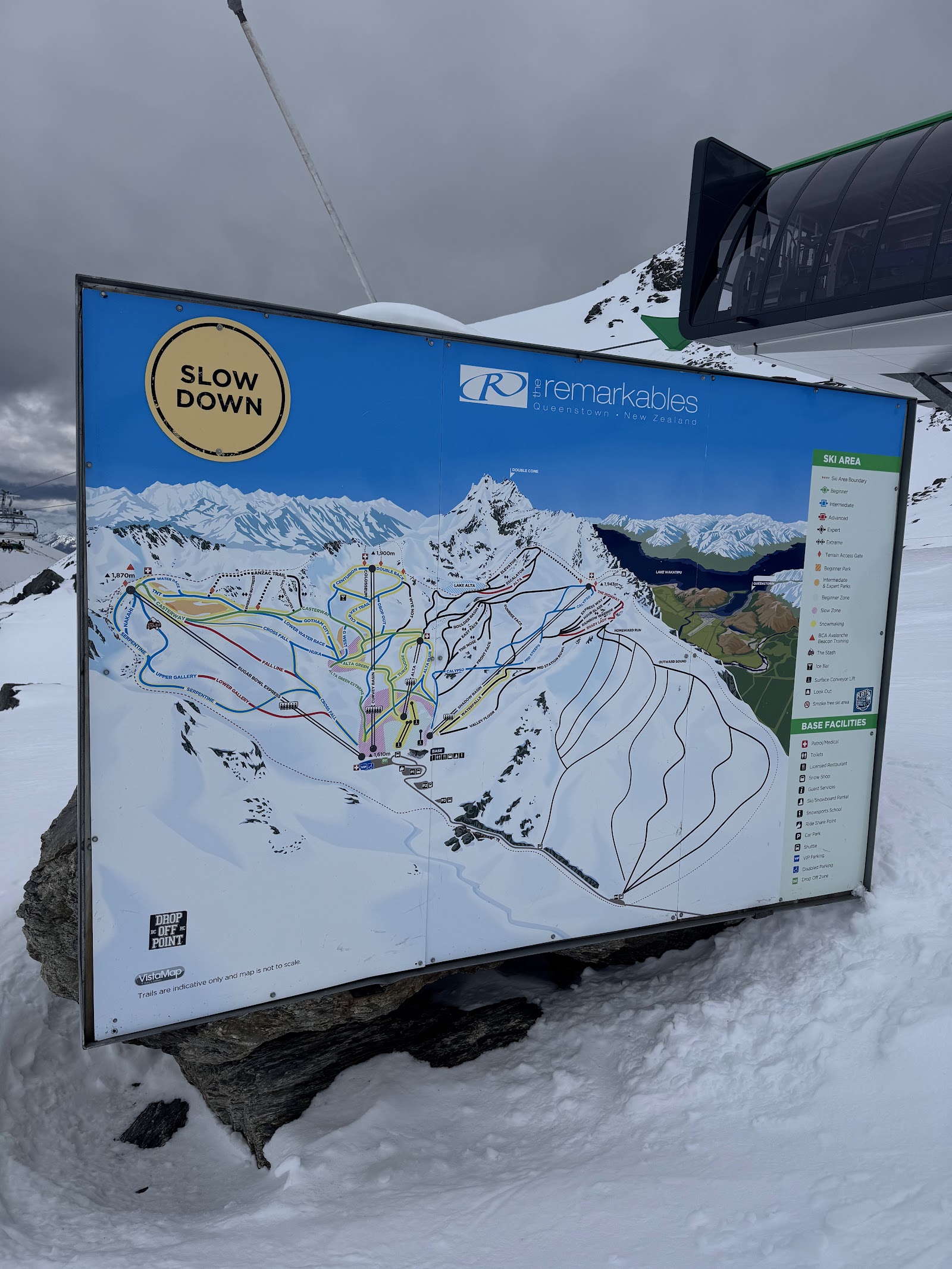 Skiers riding a fast chairlift with mountain views at The Remarkables