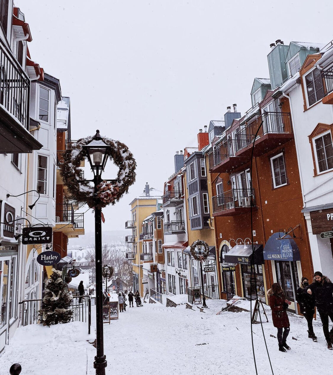 Skiers on a groomed run above the Tremblant village