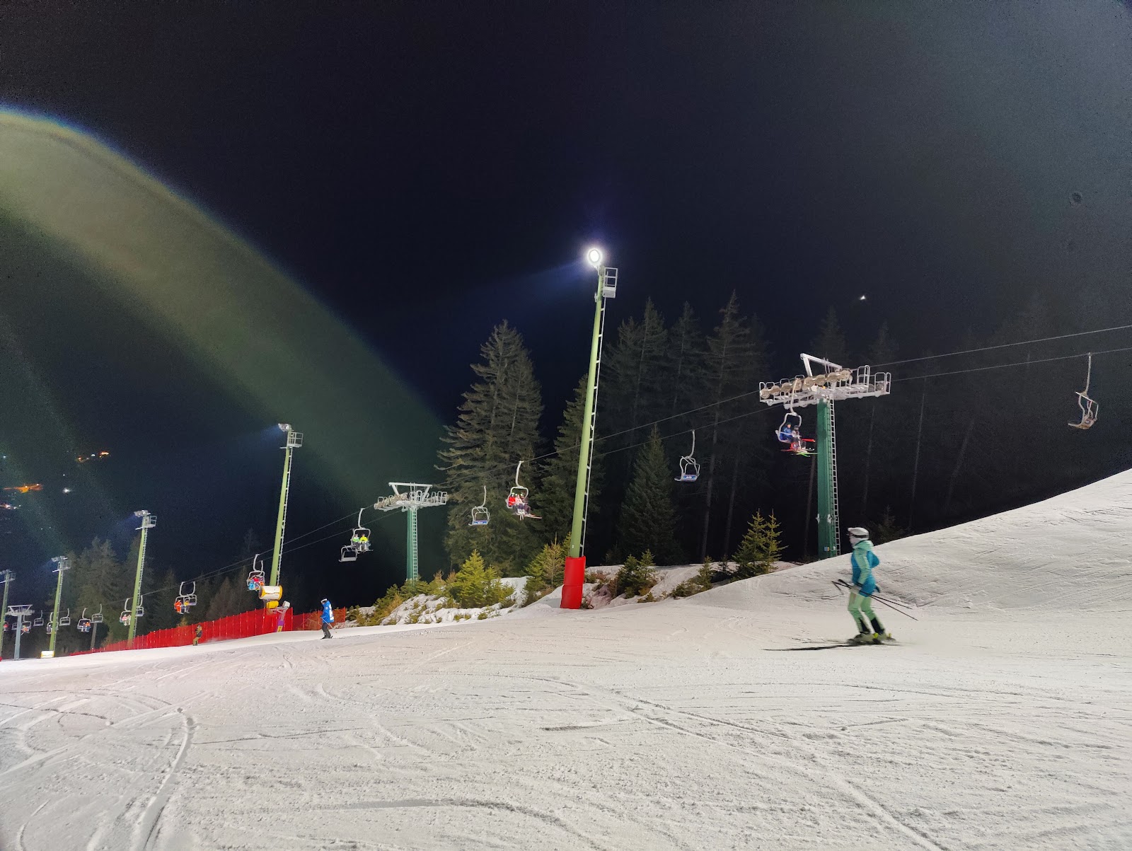 Skiers cruising beneath the Dolomites at Pozza di Fassa