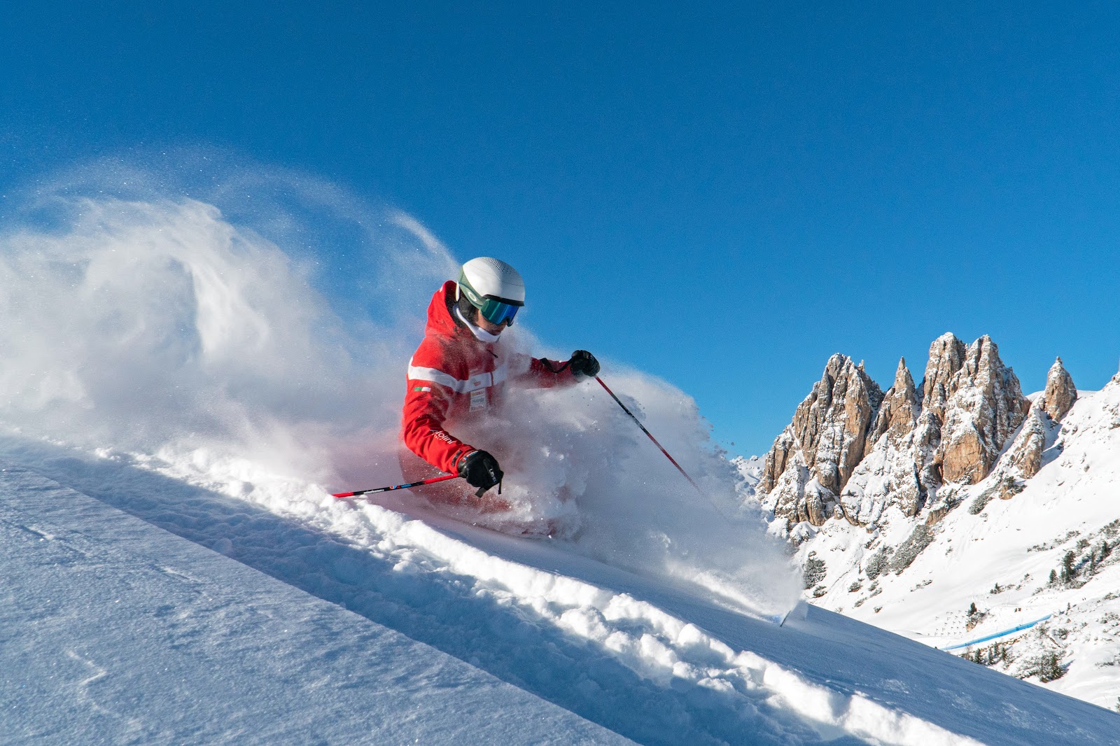 Sunny pistes above Selva with the Sella massif behind in winter