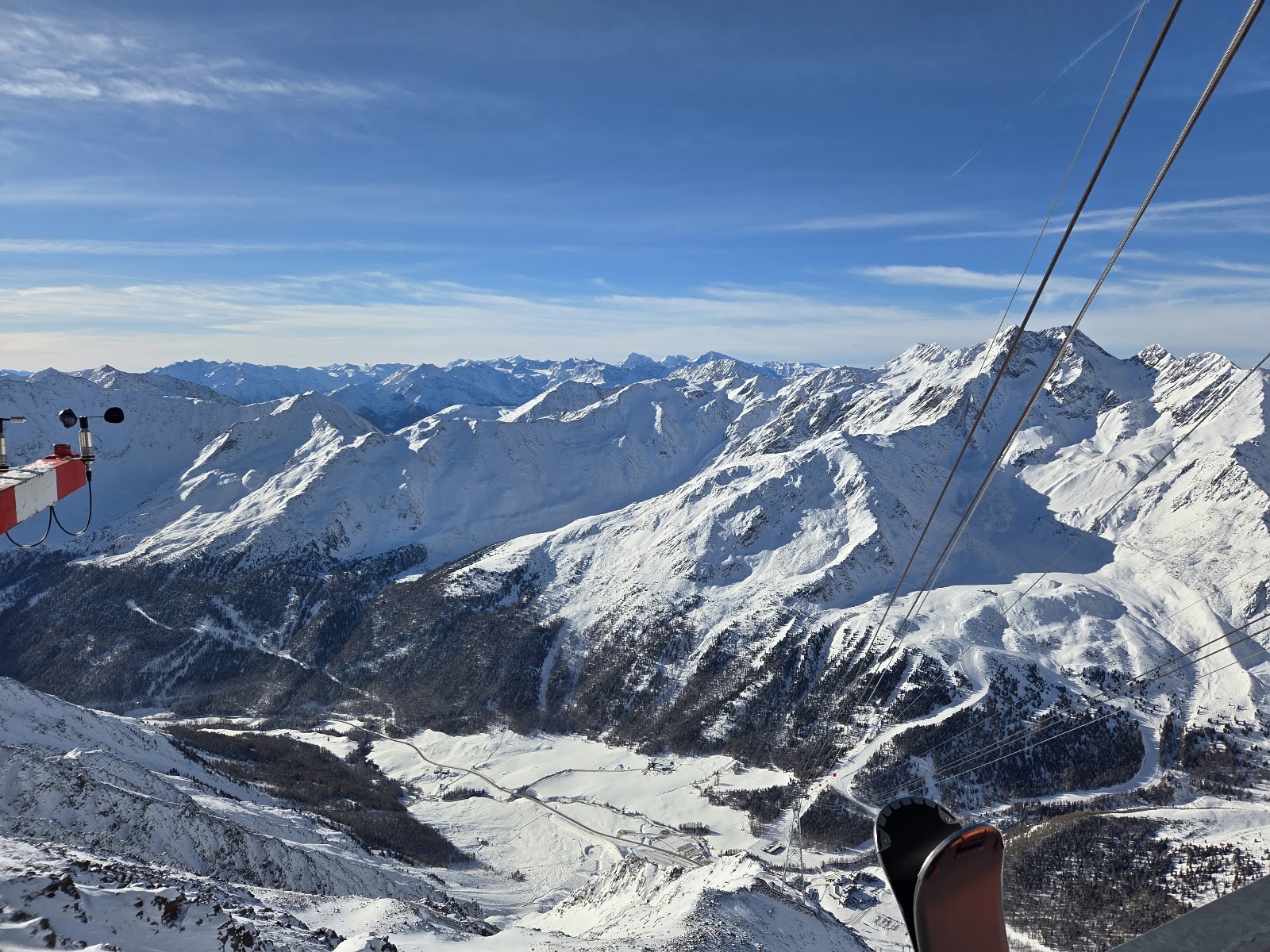A ski tourer below high glaciated peaks in the Otztal Alps