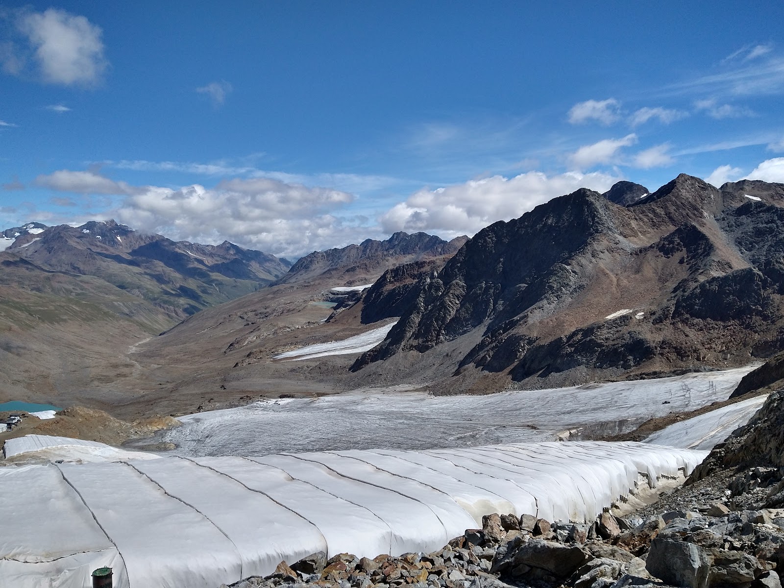 A skier on a quiet high altitude piste in clear weather