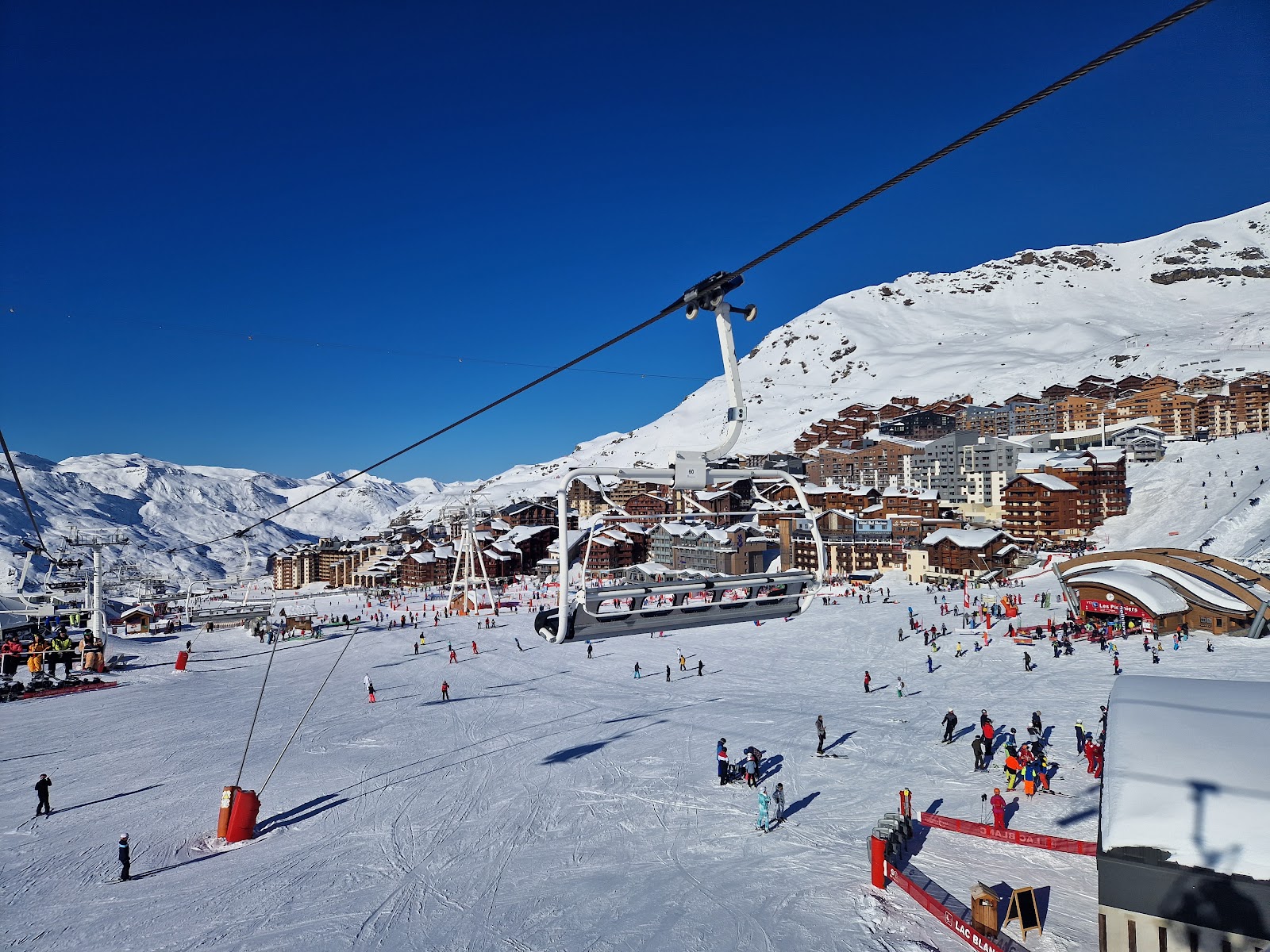 A chairlift climbing snowy slopes in the Trois Vallees