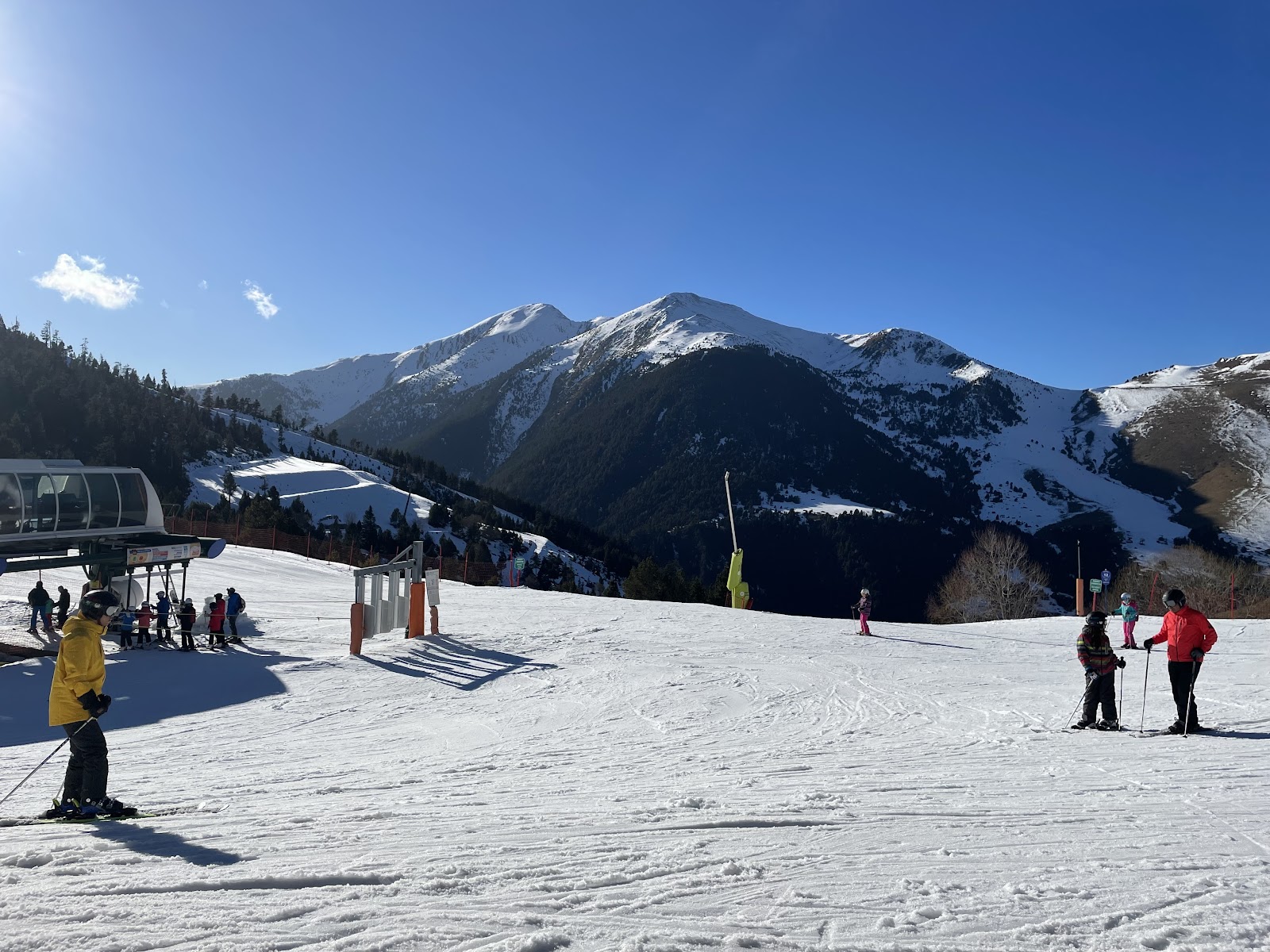 Snowy pistes and the lift base above the village of Arinsal in Andorra
