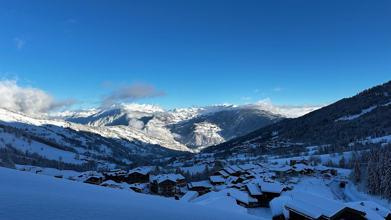 Wide gentle pistes above Valmorel on a sunny winter day