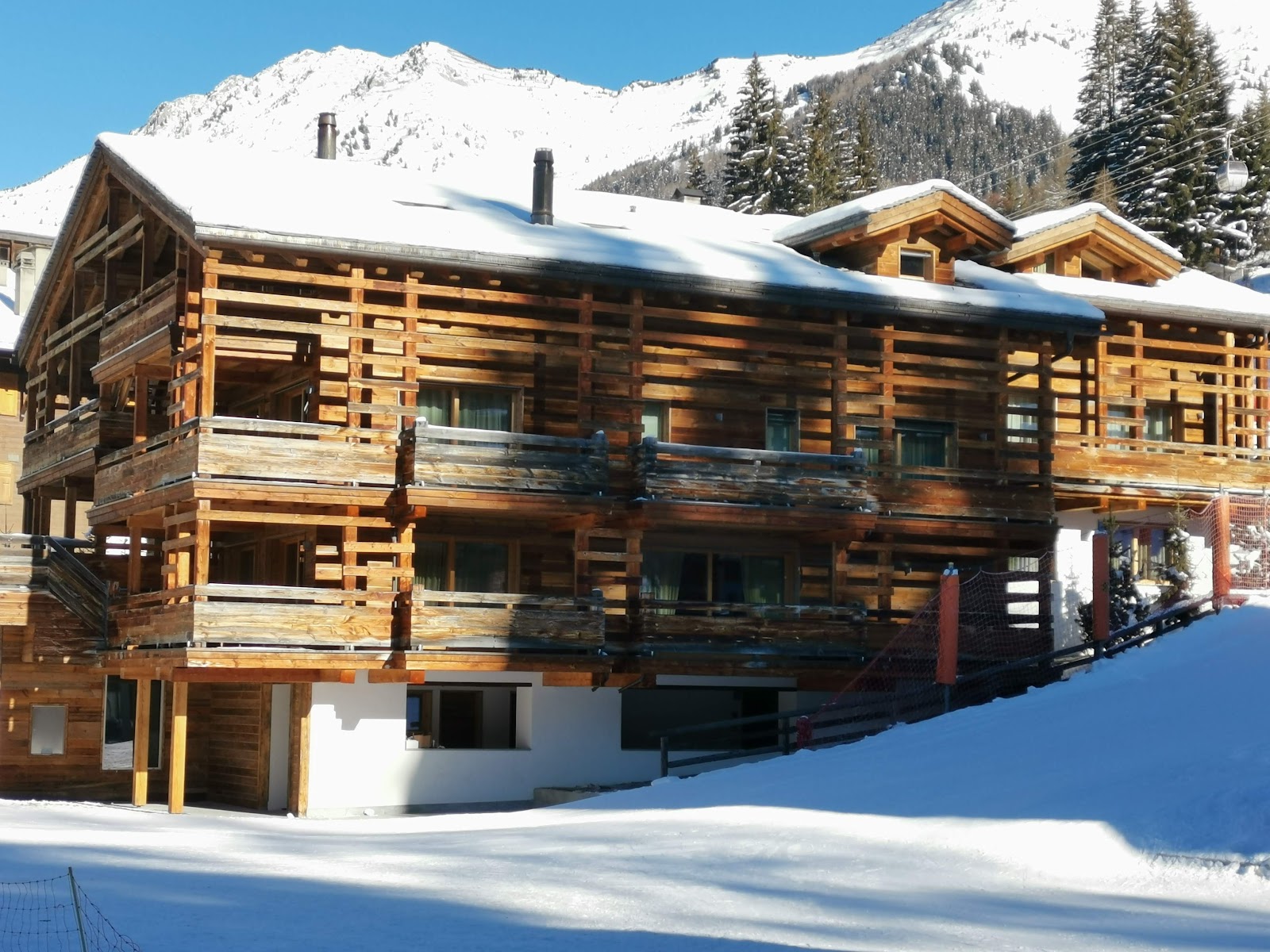 A lively apres ski terrace in Verbier with skiers in the afternoon sun