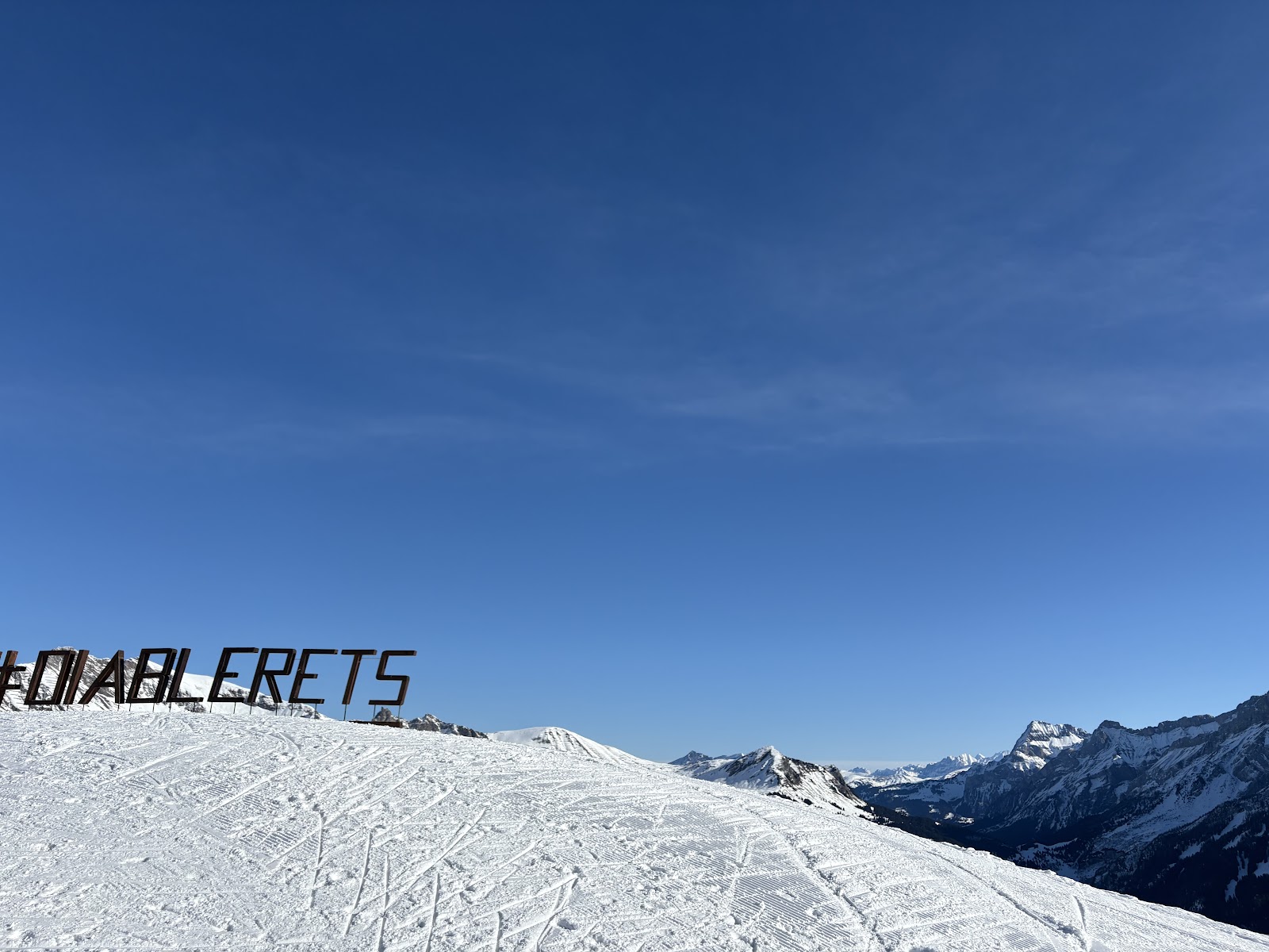 The cog railway climbing above Villars in the snow