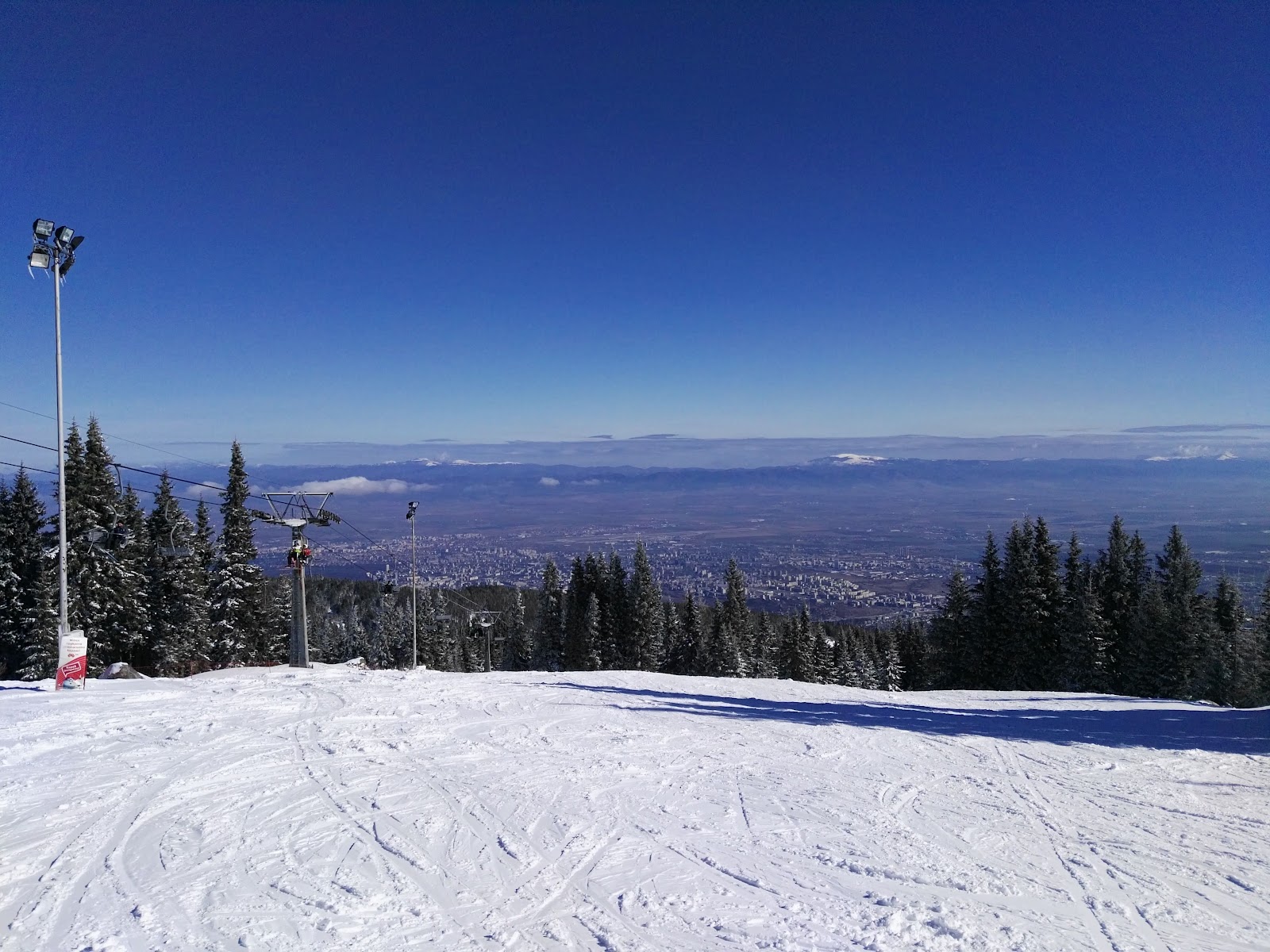 Snow covered slopes of Vitosha mountain rising above the city of Sofia