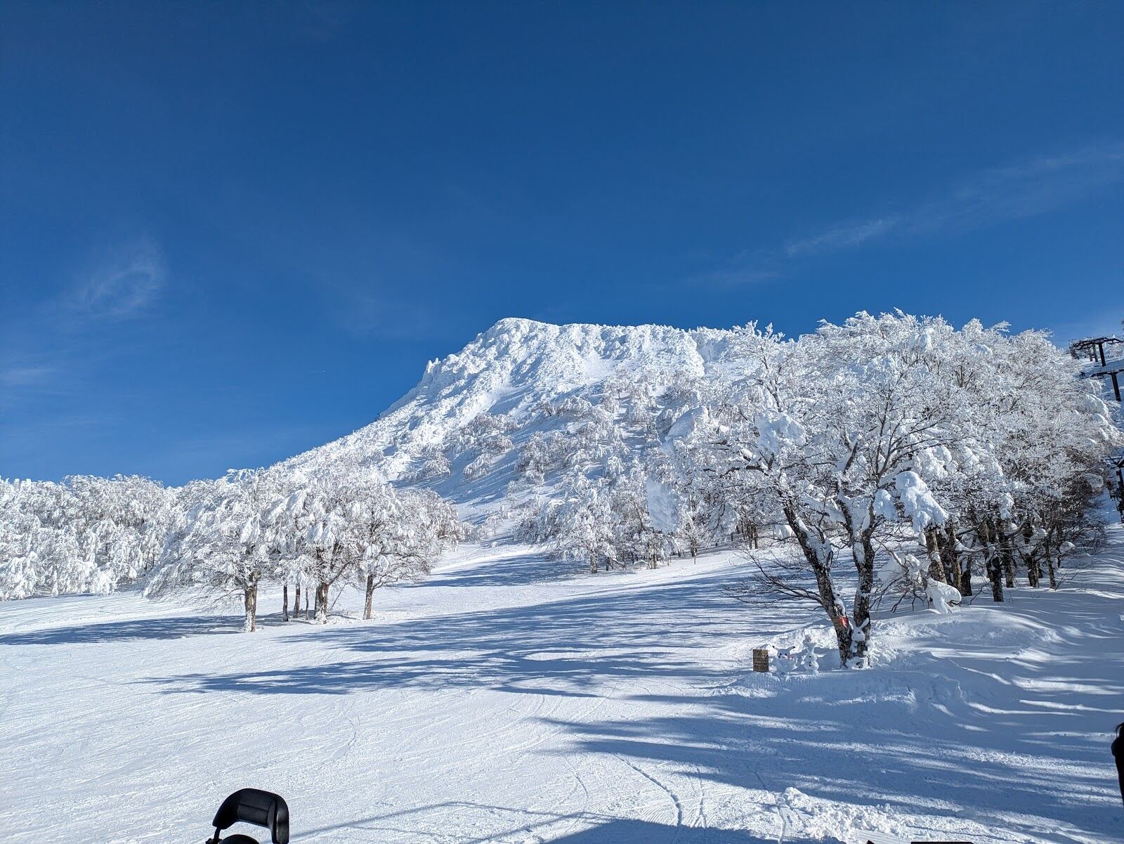 Snow covered terrain and grey winter sky above the onsen town of Zao