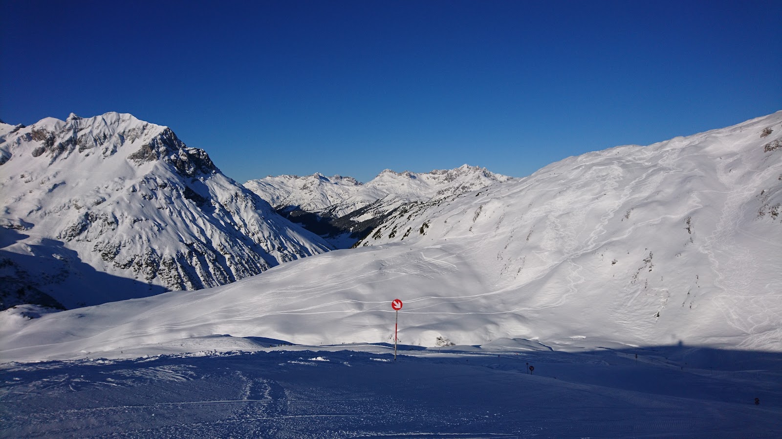 Snow covered high alpine village of Zurs below treeless ski slopes